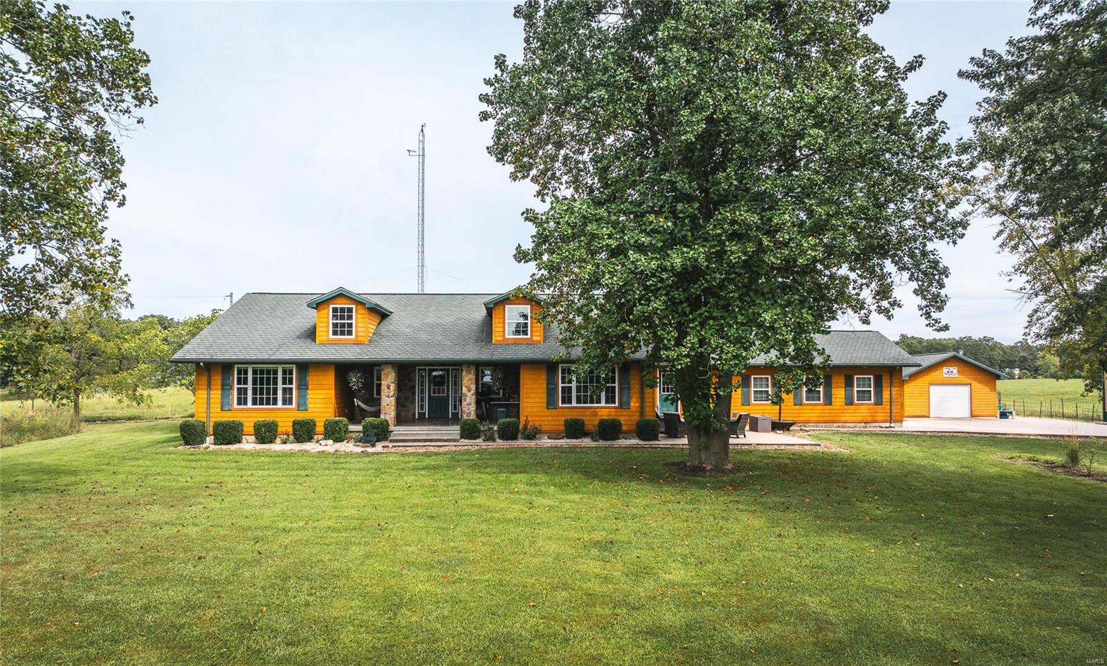 One of a kind Farm Setting on over 79 Gorgeous acres m/l. Accompanying this Exceptional & Unique Farm is a Stellar Home featuring 2 generously sized bedrooms with a possible 3rd or Home office, Large Gourmet Inspired Kitchen with Commercial, top of the line appliances, Huge Mud Room & an oversized living room perfect for entertaining. The 18' tall, 40x80 m/l shop includes 220 hook ups & air compressor hook ups all around the interior with lighting, drains, mis. and has a 20 x 80 m/l attached lean too with concrete floor.  Land is mostly open with lush grass that is divided into paddocks for livestock with available water to each. Abundant wildlife present, just in time for deer & turkey hunting season. Bring your entrepreneurial skills & imagination! This terrific property is also adorned with a four story climate controlled barn, historic log cabin/2nd residence, & the cutest mini glasshouse. This property will truly blow you away! Come & see the magic, & get ready to fall in love!