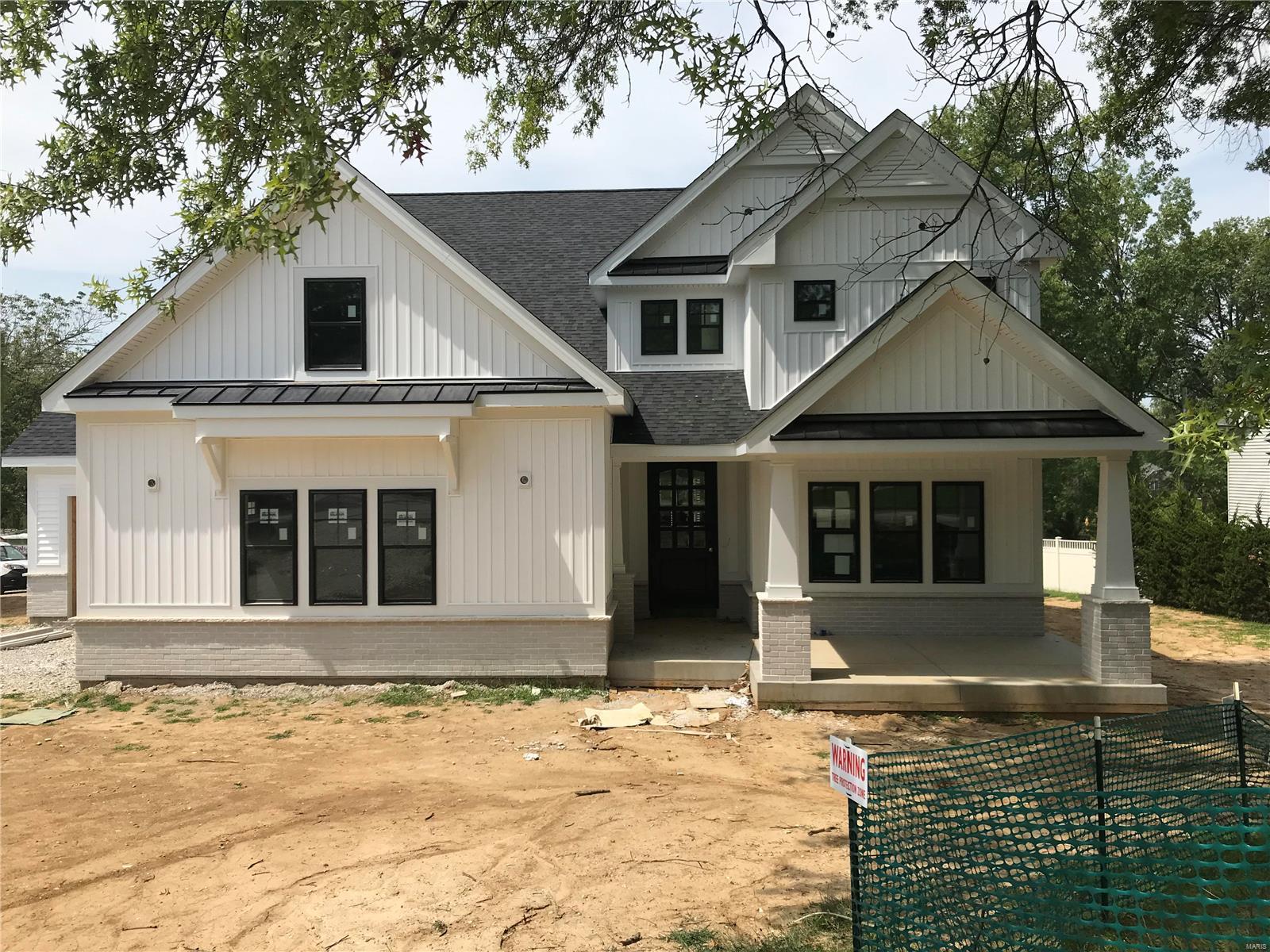 Spectacular modern farmhouse 1.5 story under construction by Boulevard Custom Homes.  This 4 bedroom, 3.5 bath, home features astounding finishes which include a 3-car side entry garage, metal roofs, job stained hardwood flooring 1st floor and 2nd floor hall, gourmet kitchen with true custom cabinetry, large island and peninsula counter, crown molding, soft close drawers, 3 lazy susan's, pull-out spice rack, trash pullout, Quartz countertops, stainless steel appliances, under cabinet lighting, large walk-in pantry, built-in lockers, and impressive screened in rear porch.  12' high beamed ceiling in great room offers a fireplace, wine bar with wine cooler,  den/study with beautiful wainscot. Elegant master bath suite boasts coffer ceiling, large walk-in closet, adult height vanities, stand alone tub in master bath.  Other amenities include mahogany wood front door, wood treads on stairs, a expansive 2nd floor bonus room, 2 full baths on 2nd floor, large bedrooms with walk-in closets. Additional Rooms: Sun Room