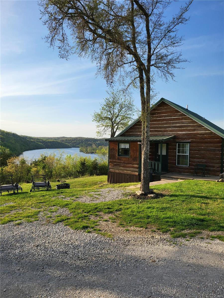 Perched high above Lake Taneycomo, one of the top world class trout fishing destinations in the country, sits Peninsula Cabin & RV Park on 18 acres m/l of the Ozark Mountains.  Located minutes from the Branson Landing, premier golfing, tourism attractions and multiple Johnny Morris Bass Pro developments, sits 3 renovated 1-2 bedroom rustic cabins with kitchens and covered porches with incredible panoramic lake views, a duplex, 3 additional cabins ready to renovate, 13 RV sites with 50/30/20 FHU with room for expansion, laundry and office complex. Bring your boat for the Rainbow Trout, Brown Trout, Largemouth Bass, Cutthroat Trout to the private dock with 2 boat slips, kayaking, hiking and more!  Solar panels provide approximately 50-60% of the power supply, private well.  Possibilities are limitless on this secluded, peaceful lake front 3 sided peninsula property.  Retire here while your investment works for you.  P&L's available, partial owner finance available to qualified buyers.