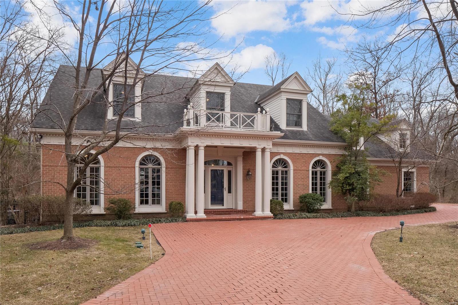 Welcome to this stately home in the heart of Ladue, built by Milton in 2003. Gorgeous hardwood floors greet you in the foyer and continue into the study detailed with wainscoting and bar. Find hardwood floors and floor-to-ceiling windows in the expansive dining room. The chef's kitchen opens to a bright breakfast room and a hearth with a gas fireplace and built-ins. Both provide access to the backyard patio. Don't miss the Dacor double ovens, Bosh dishwasher, center island with room for 4, granite countertops, and custom cabinets. The additional office could be converted to a laundry room if desired. Completing the main floor is a bedroom suite with 2 walk-in closets, Kohler soaking tub, marble floor and countertops. Upstairs, you will find 3 more bedrooms, 2 baths, and a cedar closet. A large finished area, an office, fitness room, rec room, and additional full bath is a dream lower level. Private backyard includes generator and inground sprinkler system. 3-car garage. A must-see!