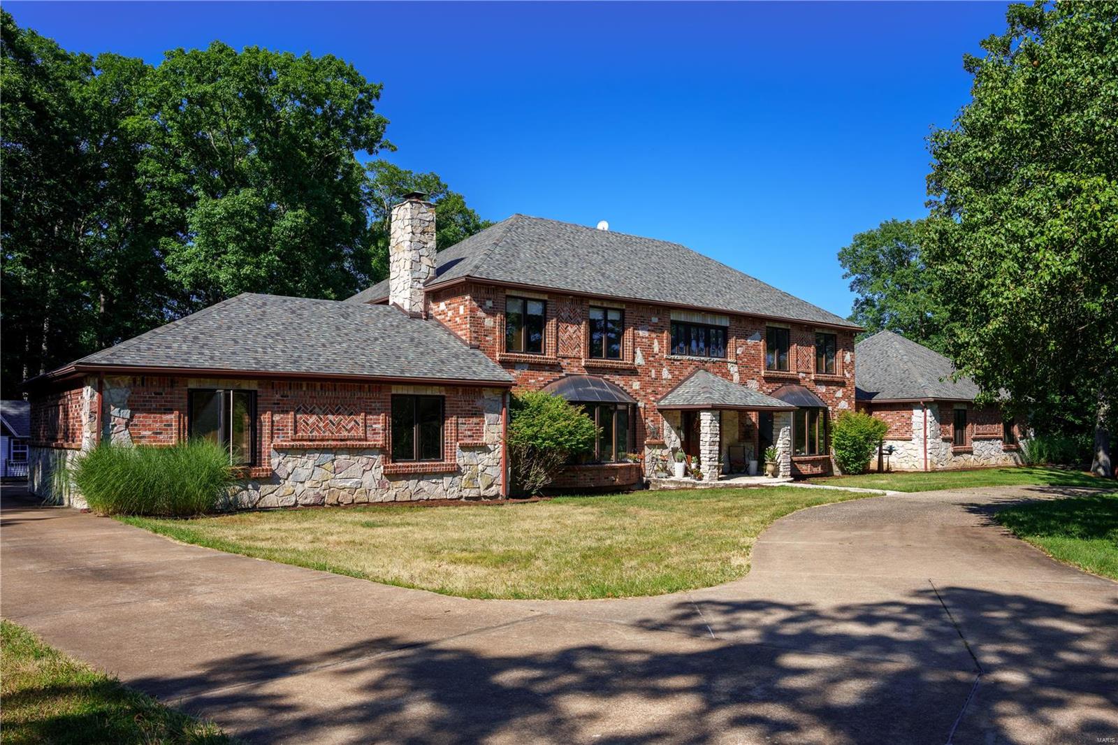 Exquisite equestrian estate nestled in the woods amongst 6+ scenic rolling acres of countryside w/1.5+ acres of open land for new buyer to make pastures & a 40x35 barn w/2, 12x12 stalls, water & elec, & tack/wash rm w/water rough-in. The estate features a cust 1.5 story,6,000+ sqft, 4 bedrm, 4.5 bath home offering 9'ceilings,4 WB FP’s,warm wood flrs,vaulted clgs,impressive architectural detail & finished LL w/MediaRm. Kitchen boasts cust oak cabs,granite counters & SS appl,plus pot filler. FamRm has cozy WBFP,wet bar, & slider to patio overlooking 18x36 pool. ML Master flaunts dbl entry door,WIC & luxury bath w/heated flrs,private commode,dual vanities,jet tub & shower. UL has SittingRm & 3 add’l spacious bedrms. Great/BonusRm has full kitchen,sauna & French drs to patio.LL extends living qtr w/RecRm & MediaRm. Add’l features:possible in-law qtr w/sep kitchen & bath,oversize 3-car garage,3 zone HVAC. Rockwood Reser is just out the backdoor & w/in walking dist to Greensfelder Park.