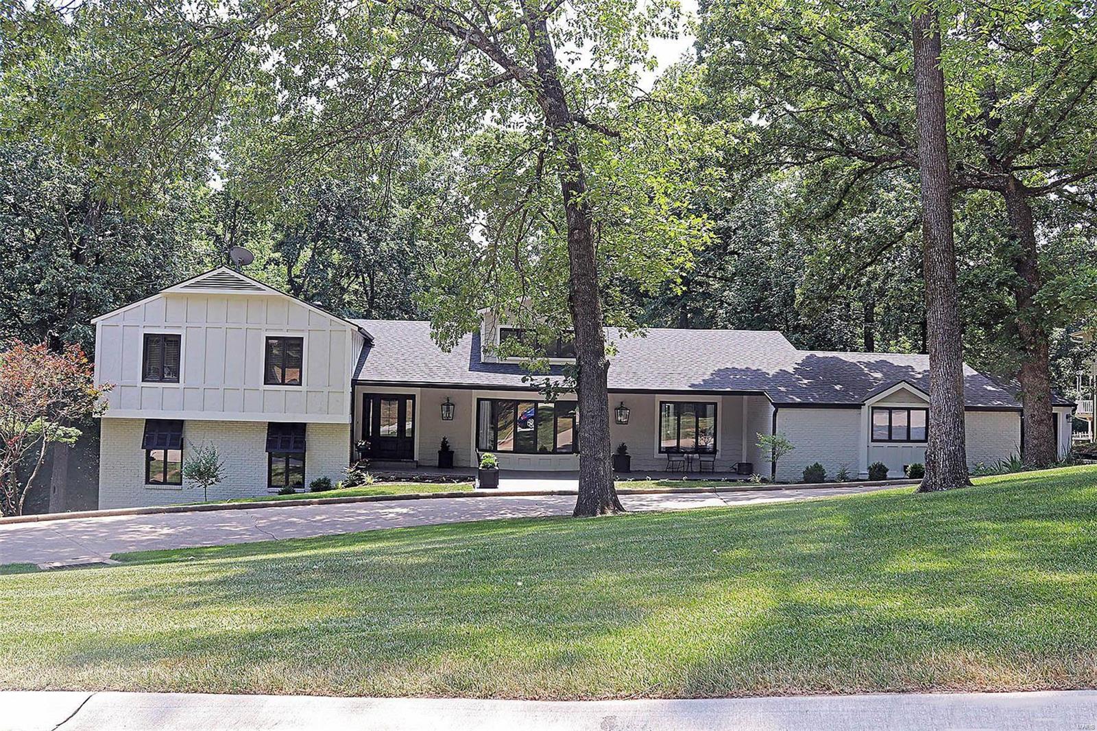 A show-stopping remodel...where no expense was spared and no detail overlooked!  This home has been gutted and brought back to life using high-end finishes on every floor.  Set on a peaceful, wooded lot w/lake views & Steve Foeste designed landscaping, here's your own private oasis right in town!  Inside you'll find flexible living spaces to ensure that this house can remain your forever home.  Featuring 5 bedrooms (4 ensuites), 6 1/2 baths, massive living room open to chef's kitchen, formal DR, theater w/kitchenette, office, FR w/bar, 3-car garage, and lower level w/full-size kitchen & exterior entrance (think separate apartment) - what more could you need?  The three-year renovation was aided by local designer Terry McDowell, whose guidance and creativity made this home one to be enjoyed by everyone who walks through its doors.  So much thought and energy was put into planning and restoration, it's no wonder the end result is gorgeous and functional in every sense of the word! Suitable for Bed/Brk COOL: 14 SEER+