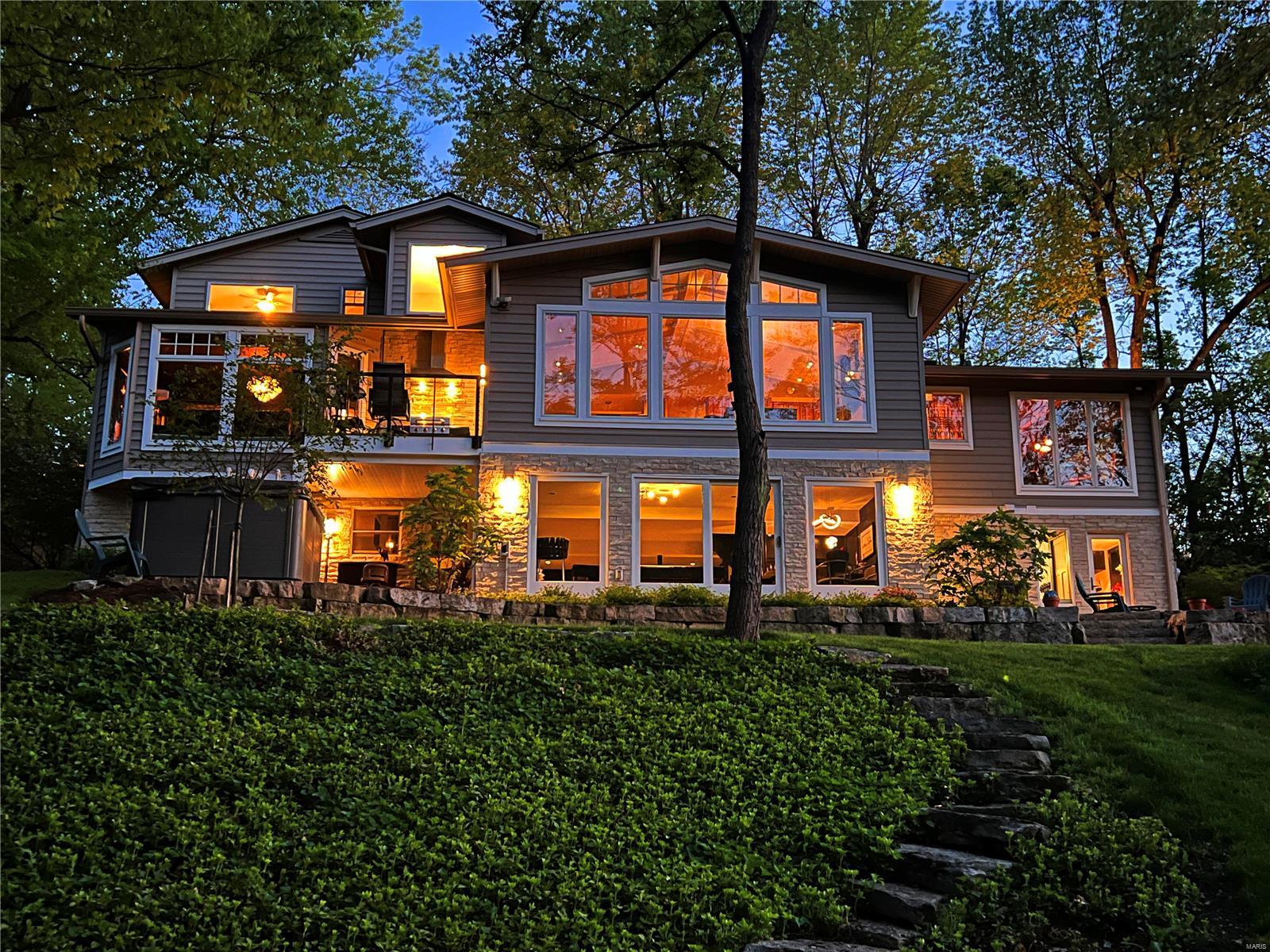 Architects live here! It is evident by the detail to style and upgrades throughout. 5+ bedroom home on private acre lot is the perfect blend of tranquility & convenience. It has smart technology, 2-car attached garage & detached 2 car garage w/room above for storage or game rm. LR has vaulted ceiling w/exposed wood trusses. Kitchen is equipped w/custom cabinets, induction cooktop, convection ovens, & a warming drawer. The hearth rm has vaulted ceiling,  built in TV & a cozy electric fireplace. Main floor primary bedroom suite has remote shades, 2 walk in closets & Wi-Fi color changing cove lighting along w/a built in TV. 2nd floor has 3 BR1 has an ensuite bath, other 2 share a full bath. LL is a finished walkout. There is a large FR has a gas fireplace & an office/bedroom w/full bath. There is another BR/exercise room & full bath, laundry room. Landscape lighting, fishpond, & flagstone walks guide you through the yard of mature trees, flowering bushes, & several outdoor patios. Additional Rooms: Sun Room
