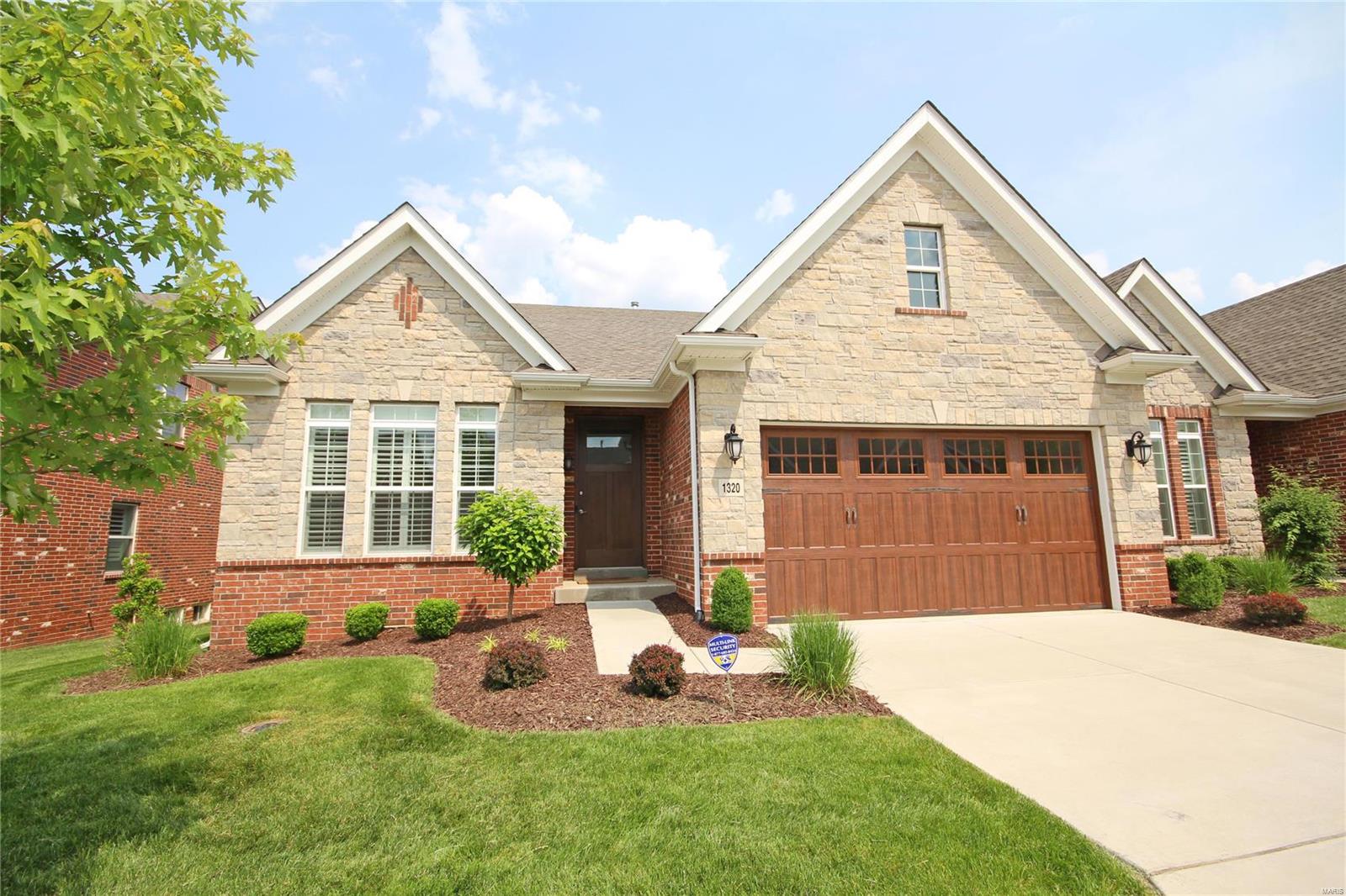 Indulge in care free luxury with a rare opportunity at this well-appointed Frontenac villa. Pass through the front door to find a spacious foyer and open floor plan of 9' ceilings, stunning hardwood floors, crown moulding & upgrades galore. The kitchen is the heart of the home with modern 42” cabinets, massive island breakfast bar, stainless Monogram appliances & quartz countertops. Large dining & great rooms impress with vaulted ceiling & stone fireplace. A gracious main floor owner’s suite boasts two closets, walk-in & large bath with double sinks. A separate den is perfect for home office. Main floor laundry with custom cabinetry & a powder room round out this level. Descend and delight as you find massive recreation space w/LVP floors, a true bedroom, full bath & immense storage in 9' pour. Attached 2 car garage, huge composite deck, 8’ panel doors round out this exceptional home at the heart of Frontenac. The owner spared no expense in options throughout the 3200+sf living space!