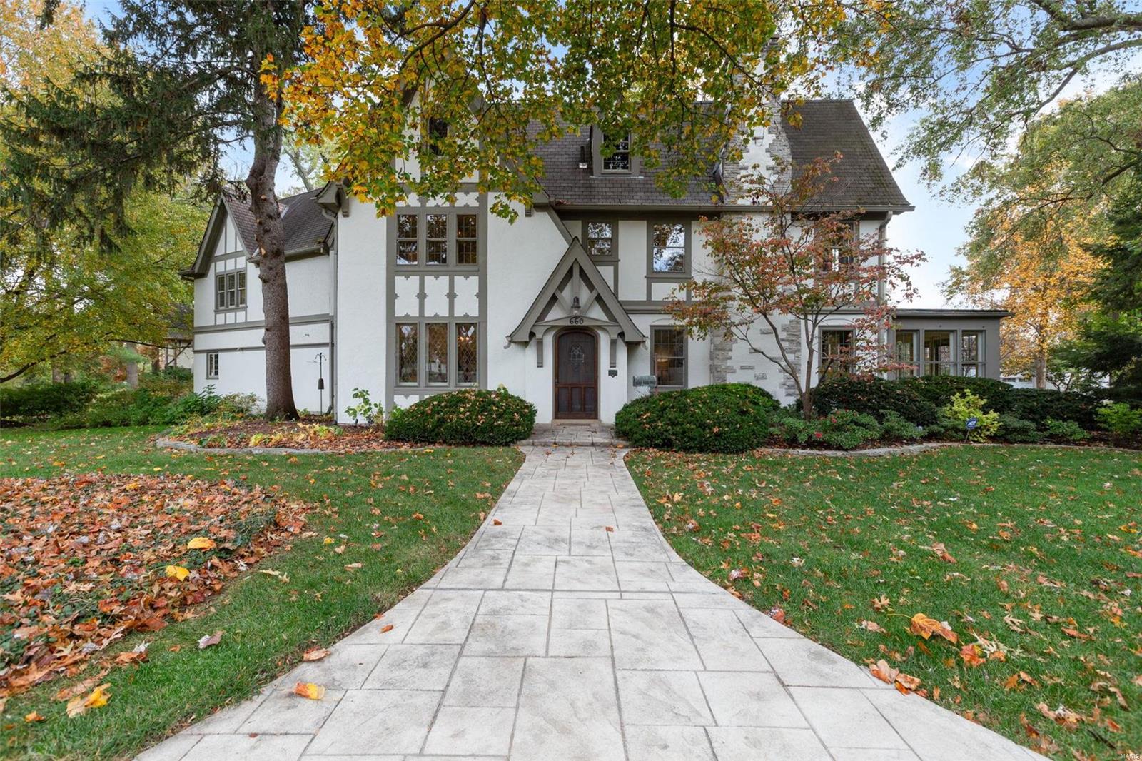 Welcome to 660 North Clay, a 1927-built 5 bed, 3.5 bath historic gem, available for the first time in nearly 4 decades. Set on over 1/2 acre & just a short walk from downtown Kirkwood’s vibrant restaurants & shops, this beautifully preserved home combines timeless charm with thoughtful updates. Inside, discover stunning original details: vitrolite tile, leaded glass windows, walnut beams, & a grand stone gas fireplace anchoring the great room. The eat-in kitchen, featuring custom cabinetry, a built-in window seat, & an original built-in buffet, flows into the large dining room-perfect for entertaining. A back staircase adds both convenience and charm, leading to the private upper level. Upstairs, the expanded primary suite offers a cozy fireplace, coffered ceilings, a soaker tub, & a walk-in closet. Outdoors, enjoy a brick patio and a stamped concrete walkway at the front of the home, along with a 3-car side-entry garage. This extraordinary home is ready for its next chapter! Additional Rooms: Sun Room