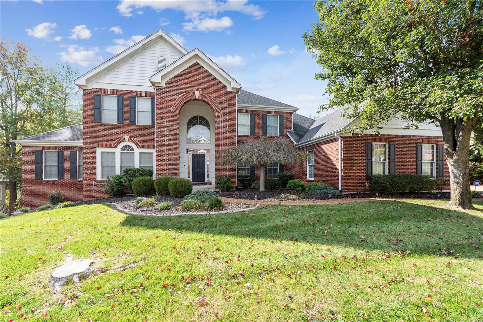This lovely 1.5 story is located in the desirable Pine Creek neighborhood and offers a very gracious floor plan with spacious room sizes. A 2 story entry with grand staircase separates the formal LR with glass French doors and DR. The 2 story GR has a wall of windows with beautiful views to the rear and pass through wet bar to breakfast room. The kitchen is very well laid out with cherry cabinets, granite counters, stainless appliances. Center island opens up to both the BKR and HR with stone fireplace.  The first-floor master is very spacious with large master bath/dual vanities/make up area.  First floor laundry as well.  Upstairs there are 2 bedrooms that connect to a J&J bath. The 4th bedroom has it's own in-suite bathroom.  The large bonus room finishes off the second floor.  The LL is a WO and is finished with two large rec areas, walk behind wet bar and 5th bedroom with full bath. Rear yard is home to a very pretty inground pool with mature trees scattering the yead for privacy.