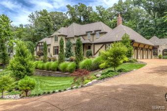 Spectacular finishes in this custom estate home. Seller has added over $800,000 in extras including amazing lower level, salt water pool, spa,outdoor fireplace,outdoor custom screened in room w/stamped concrete floor & TV. Features include Knotty alder doors, hickory wood & limestone floors, stucco wall finishes, crown mold that add to the charm of this stone home on a private treed lot. The kitchen is a cook's delight with plenty of counters and conversation spaces. Features include a Wolfe range, pot filler, butcher block baking center, pull out drawers, Subzero refrig, granite counters & main floor wine cellar. Perfect for entertaining. Wood beams, copper sinks, main floor bar. Lower level includes 10' pour, plank wood floor, frpl., exercise room, 5th bedroom suite, with steam shower, billiards room, stone walls, large bar area,True beer refrigerator system, dishwasher,microwave,mirrored glass shelves, granite counter. All bedrooms are suites. Gardens are lush.A Perfect family home.