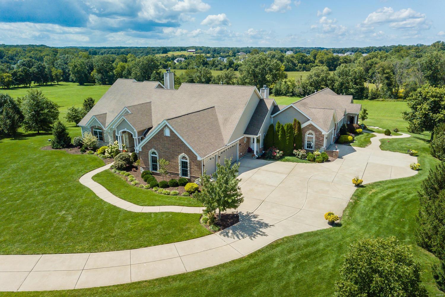 Looking for property with room & privacy for your family plus maybe your parents, grown children or private work area? This home is perfect for those who want to have a luxury home on acreage & need space for extended family or space to work from home! Enjoy fabulous Sunsets on this private, almost 4acre lot, in upscale Avondale Meadows, just off Hwys 40/64 & DD! Approx 9000 fin sqft w/5500+/- sqft of Main Level living - 4000+/- in Main House/1500 +/- in the gorgeous adjoining inlaw residence! Both offer extensive finished walk out lower levels! 5 fplcs, 3 kitchens, multiple Great/Family/Rec Rms, 7 bdrms (2 sets share J&J baths), 5 full/3 half baths! Quality features incl FiberCement siding, multiple HVAC systems w/electronic air filters, finished garages, custom landscaping/Koi Pond. Huge Patio area w/great set up for future pool! Horses allowed, w/plenty of pasture/space for Barn! Super location w/easy access to hwys, shopping & limited commute time to St. Louis County! HSA Warr,MORE