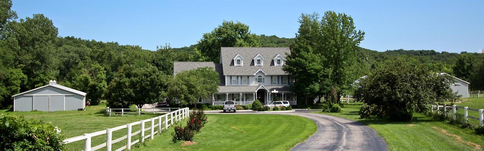 Luxury estate for the TRUE horse lover, 26 stalls, in & outdoor arena. 14.1 ac w/ pasture turn-out & Centaur fencing. 2 wash racks & tack rms, office & full bath. Home has newer architectural roof, ball & pin millwork on front porch w/ ceiling fan. Dining rm & living rm w/ bay wndws, crown molding & chair rail. Large foyer w/ custm stair rails & balusters, wood floors thru-out ML & UL. Family rm w/ built-in bookcases, custm ceiling millwork & wood FP. Sun rm w/ coffered ceiling & walk out to large patio & inground pool. Ktchn w/ new granite counters, stainless appliances, island, desk & 42" cabinets surrounding bar. ML laundry & half bth. UL Master Suite w/ dble sink, sep. shower, whirlpool tub, 2 closets & walk-in closet. 2 add. bdrms each w/ bth & large closets. Walk-out LL w/ custm millwork, new carpet, Add. LL ktchn & bar, living rm w/ wood burning FP, full bath, laundry, & 3 sleeping rms. Dual HVAC, 4 car garage, Morton barn w/ concrete floor, insulated 48x52 for tractors & cars.