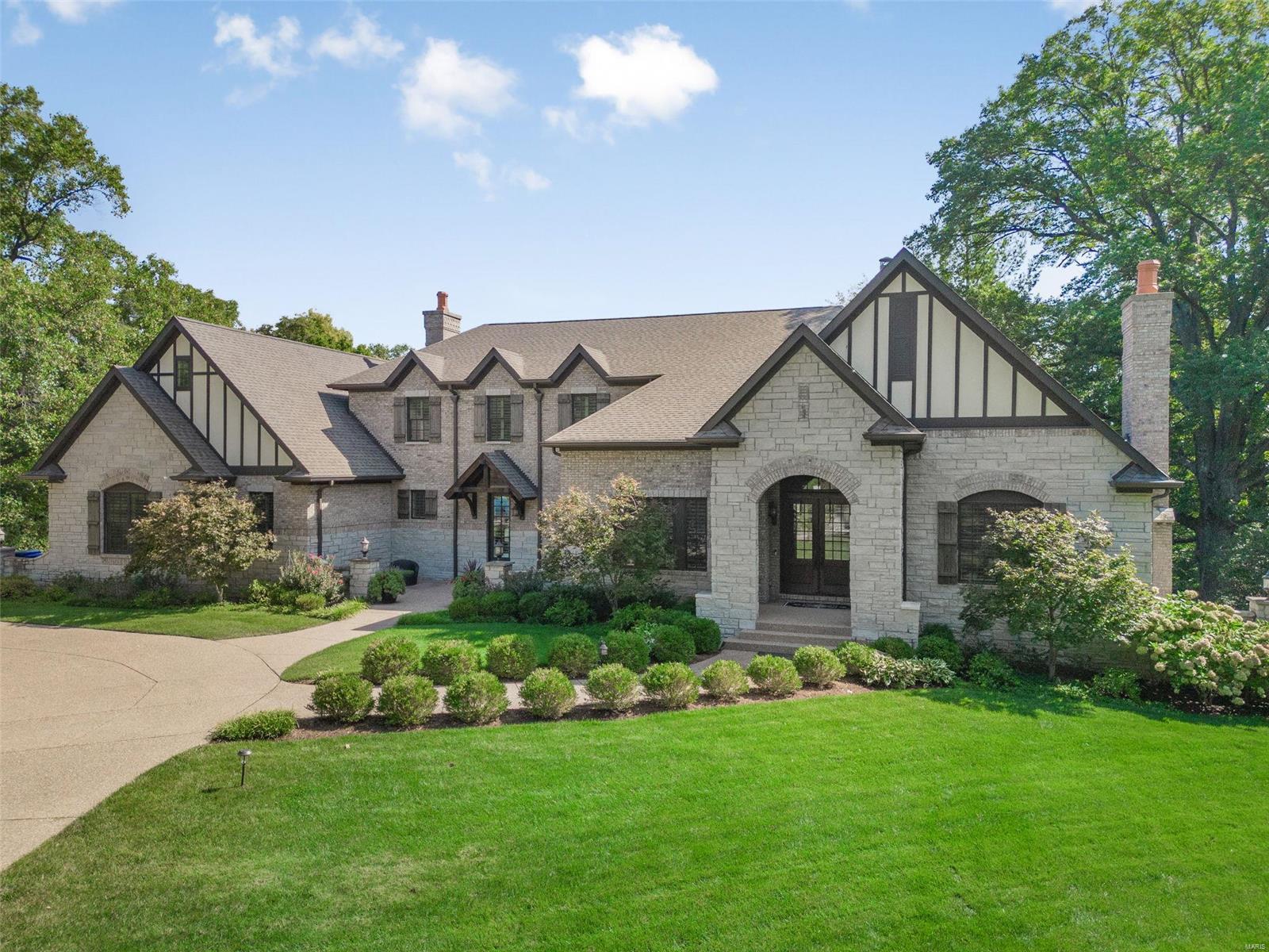 Outstanding newer English home situated on almost 1 acre in Frontenac offers all of the indoor & outdoor spaces desired by today's buyers! Fabulous floor plan of approximately 5,646sqft w/architectural details throughout: 2 story entry, spacious dining room, home office, great room w/box beam ceiling, wall of windows & fireplace, open gourmet kitchen/breakfast/hearth room w/custom cabinetry, granite counters, center island, stainless appliances, Viking 6 burner gas range/oven, fireplace, butler's pantry, walk-in pantry, laundry room, mud room w/desks & cubbies, 2 half baths, primary bedroom suite w/walk-in closet, luxurious primary bath w/double vanities, tub, stall shower complete the main level. Second level:large family room, sitting room, 3 additional bedroom suites each w/full bath. Lower level w/additional 1,062sqft finished area: recreation room, half bath, unfinished storage area. Enjoy the fenced yard, pool, outdoor living room & kitchen, fire pit. 4 Car garage. Ladue schools. Additional Rooms: Mud Room