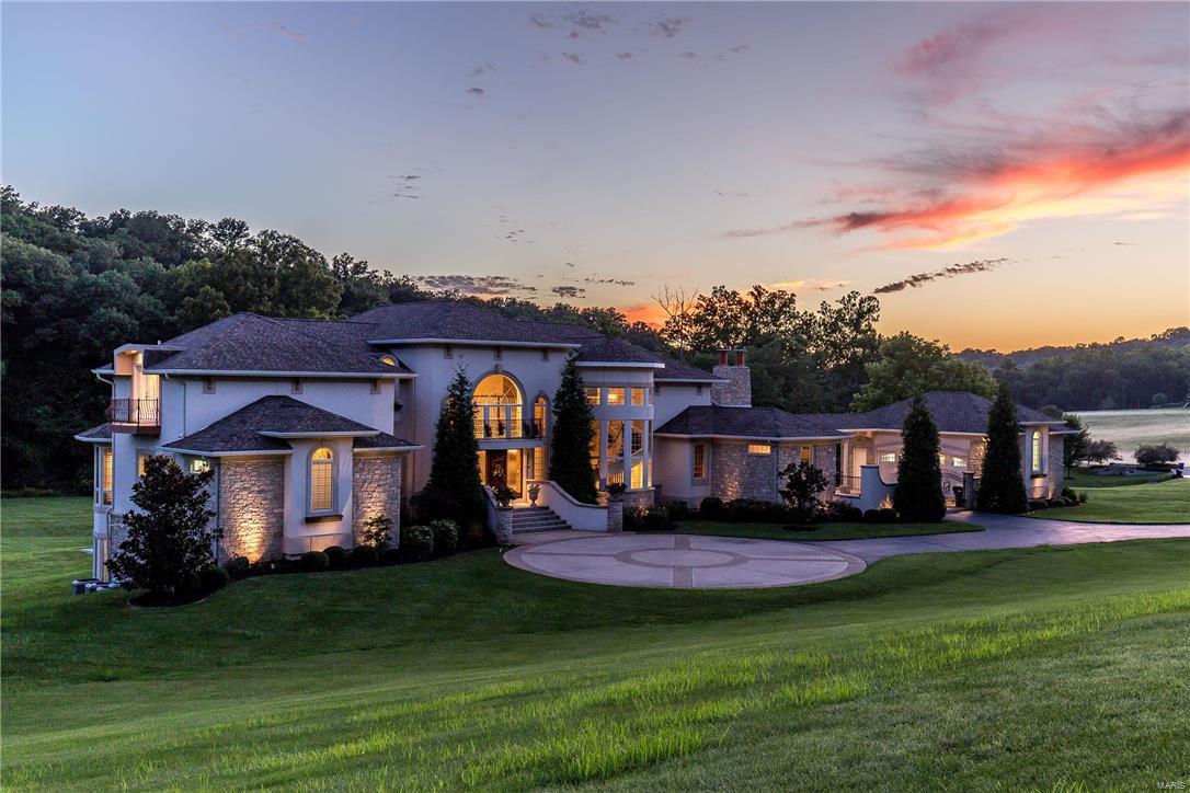 A luxurious French Country Estate, tucked away in nearly 2 acres of privacy yet centrally located awaits the most distinguished buyer. As you enter from the gated courtyard, warm hardwood floors greet and guide you through the gem of Larimore Valley. Even the smallest details were tended to in designing this home to accommodate grand events as well as those intimate family
moments. Imagine the memories created in the hearth room in front of the warm fire while gazing through the wall of windows. The open floor plan is accentuated by a grand 3 story spiral staircase that leads to the oversized secondary bedrooms all with private balconies and 2 walk-in closets. Picture yourself on the deck or covered patio unwinding facing the lush yard and trees
while the family spends time on the private sport court. There is no end to the indulgence found here, this is the palace you have dreamed of!