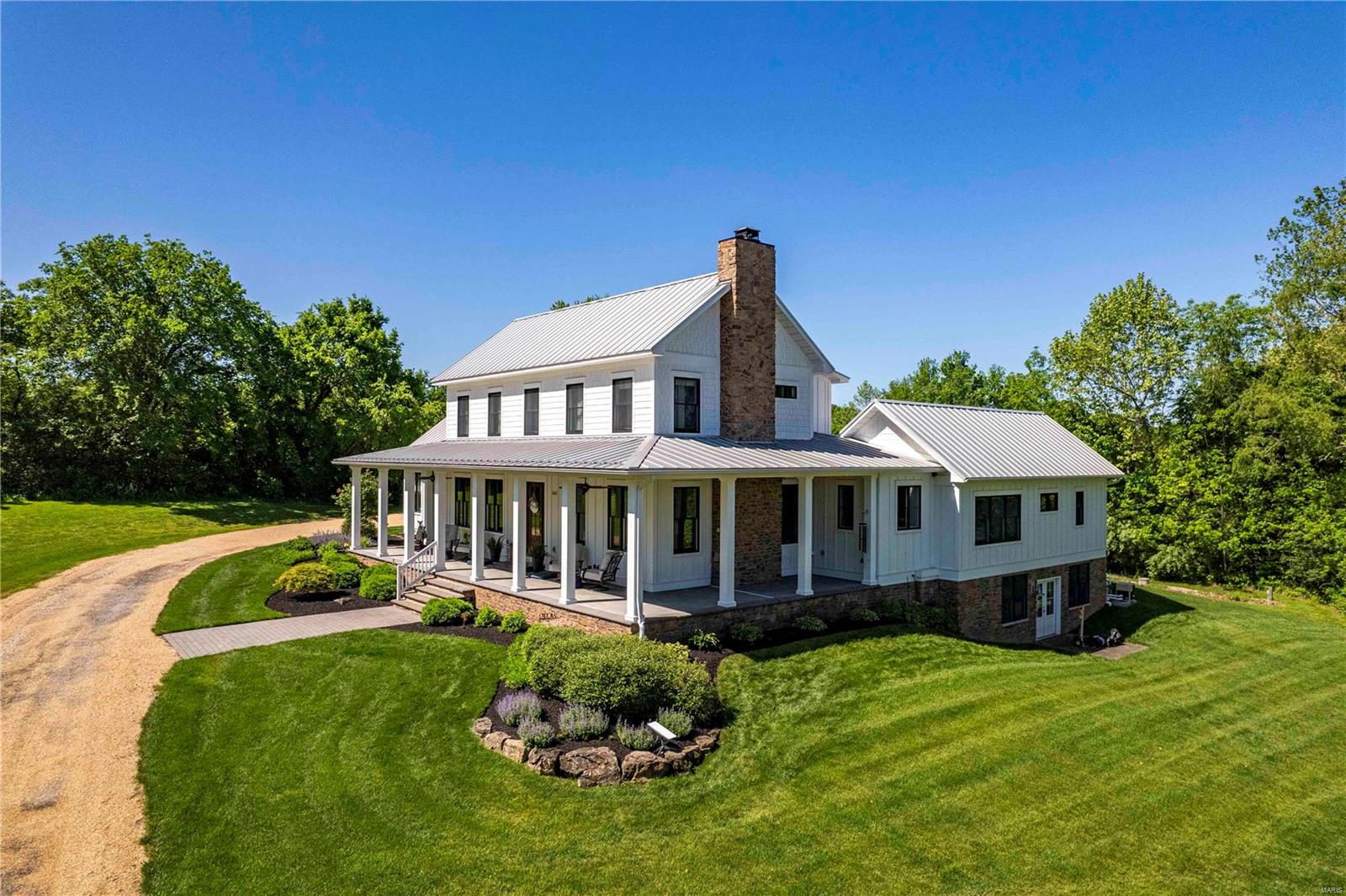 This beautiful custom-built home sits on 11-acres. The nearly 3,700 sq ft home features open kitchen, dining, and living areas with ceiling beams, stone fireplace, and gorgeous wood floors. The kitchen has a large center island, Thermador appliances, beautiful inset cabinetry, and convenient wet bar. And the comfortable den will be your favorite gathering spot. The spacious master suite includes upscale bath, organized closet, adjacent laundry room, and direct access to the pool and hot tub. Completing the main level are a 3-car garage, mudroom with lockers, and pwdr room. Backyard oasis has a covered living area, stone fireplace, TV, and beautiful pool. Upstairs has 2 bdrms with ensuites, a shared loft, and flex room. The unfinished LL includes rough-in bath, double exterior doors, and large windows. The 40’x40’ barn is currently utilized as a shop with water and electric on site. This private retreat is just 2-miles from Labadie and 7.5 miles from the Country Club of St. Albans.