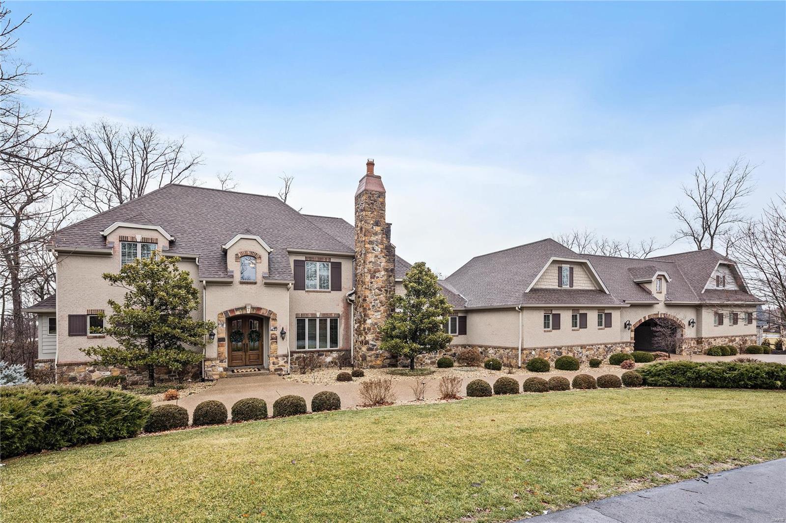 Welcome home to a beautiful setting & stunning estate home that is comfortable yet elegant. A home that's an entertainer's dream & perfect for a family. Owner has made many additions including a port-cochere w/second garage building (brings the total to 7+ garage spaces for the car enthusiast)w/separate entrance to guest apartment above garage. A grand entrance to pool, bar/cabana entertainment area which includes TV, ice maker, refrig, & misters for our hot St. Louis summers. The home's interior offers a floor plan w/great flow. Seven fireplaces including one in Master Suite. Chef's kitchen is open to an inviting hearth room & breakfast room w/French door leading to large IPE deck. Kitchen features newer refrigerator, dishwasher & beautiful custom cabinetry w/a top row of decorative and interior lit cabinets .The main floor bar area is located perfectly to accommodate all entertaining. All 4 secondary bedrooms are ensuite w/large walk-in closets.Dog wash shower.Something for everyone!