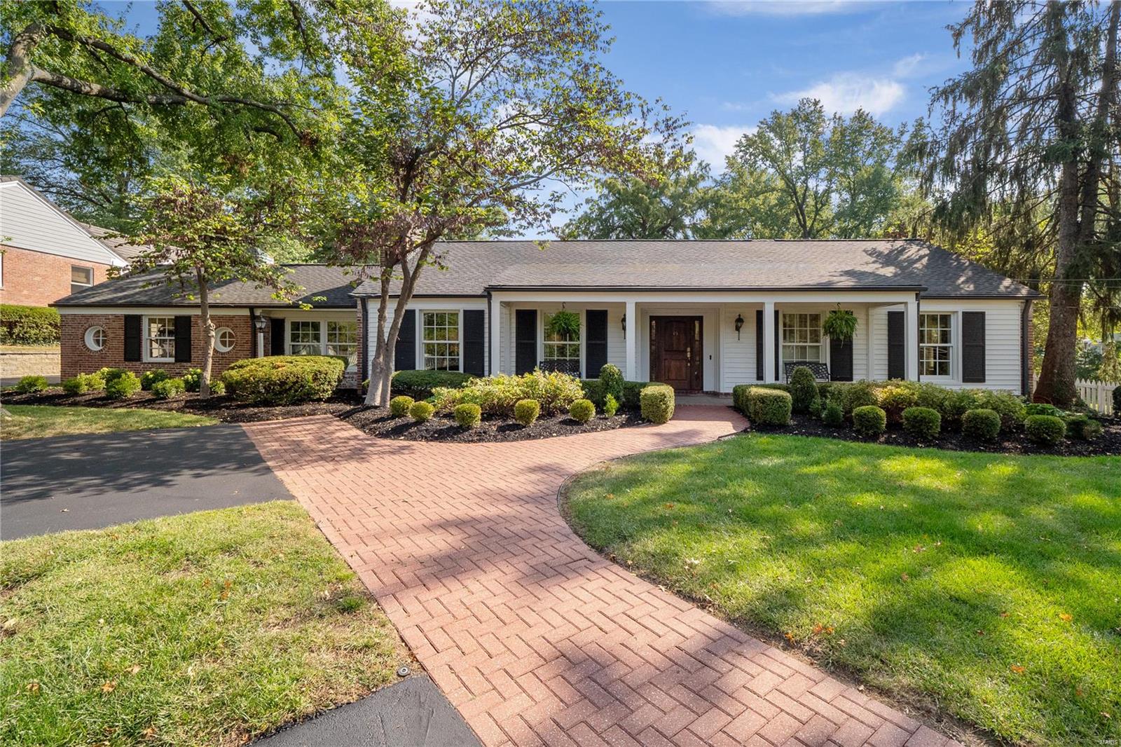 If your home is to be all things - a sanctuary for graceful one-level living, a backdrop for carefree indoor/outdoor leisure and entertaining & space for home offices, this ranch, set in a parklike magical setting w/a resort-like inground salt-water pool, in a prime Ladue location, will excite you. The entry opens to a LR w/plantation shutters, millwork & fireplace. The elegant DR offers a picture-perfect view of the patio & pool. The updated kitchen is stylish & functional & features quartz counters, tiled backsplash, breakfast bar & stainless appliances, making this the heart-of-the home. A luxurious primary bedroom suite opens to the patio & pool. Bedroom two has a full bathroom suite. Bedroom three & four, 3rd full bath & powder rm, plus laundry on the main, makes life so easy. A study & den completes the main. The LL offers a rec. room, 1/2-bath, bonus rm & storage. 1-Car attached garage (used as a work-out studio) with attached full bathroom. 2 Car detached garage. Move-in ready.