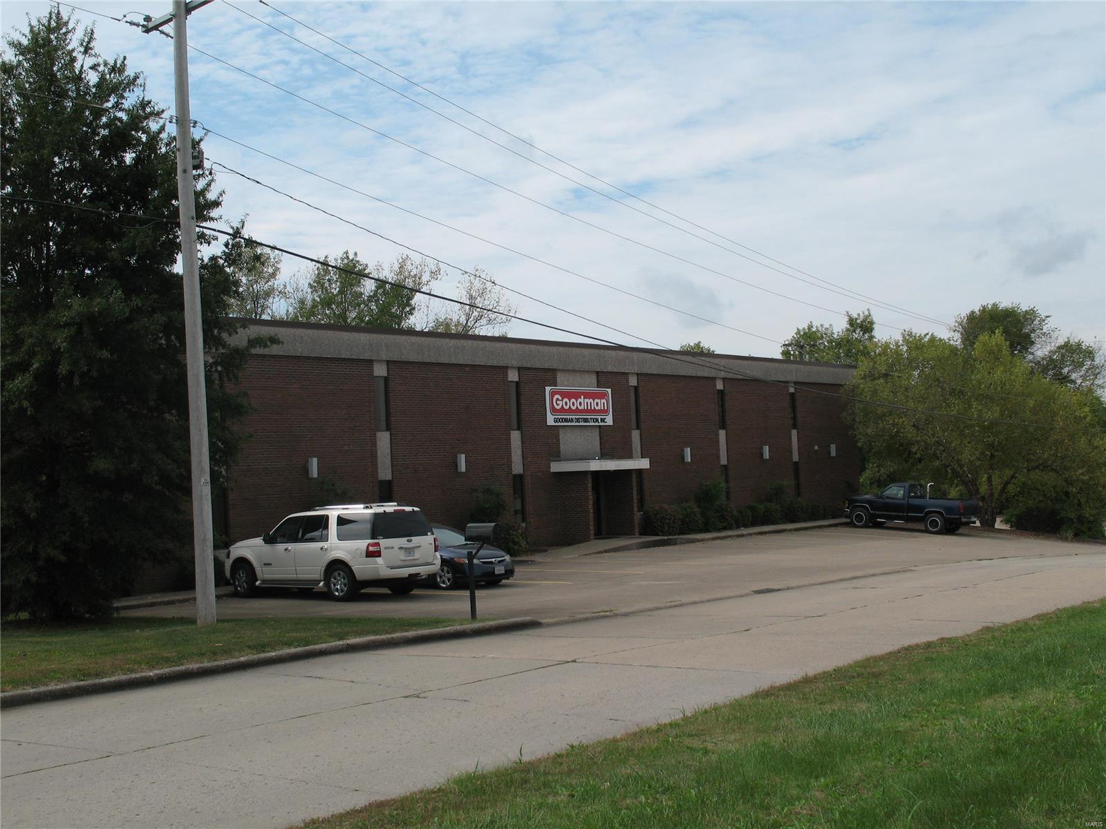 21,980 SF commercial building with showroom, office areas, warehouse with three loading docks, one elevated ramped drive-in door. Location: City, Industrial Area