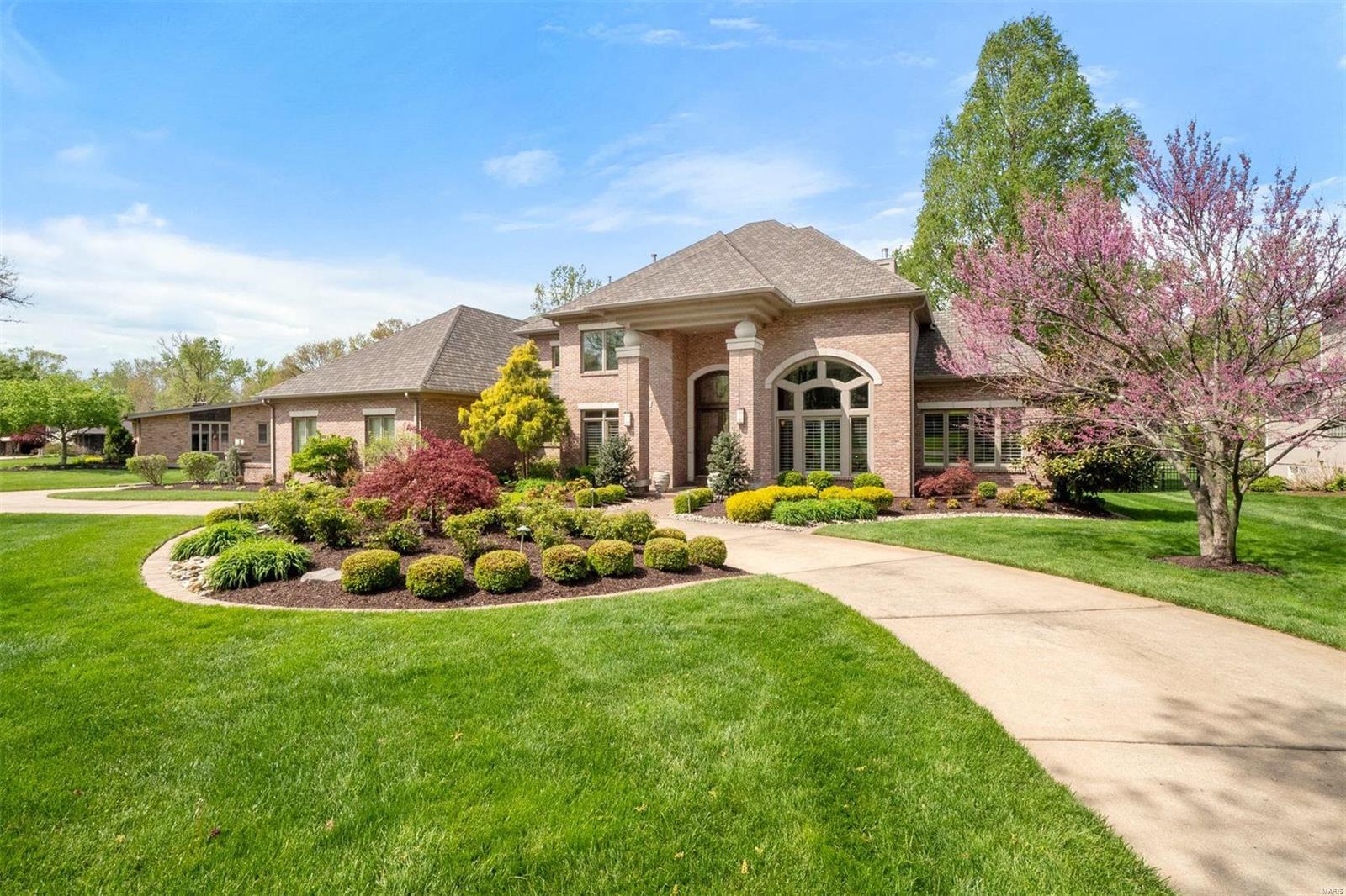 Pristine custom home in Ladue Schools offers nuance and luxury throughout.  Be taken by the immense ceiling height, wrought iron railings, dramatic windows, and sleek hardwood floors in the formal areas. The Chef's kitchen has commercial-grade appliances, a massive island, and exquisite custom cabinetry.  Adjacently, the hearth has vaulted ceilings and a fireplace flanked by built-ins.  Easily transition outdoors to the plus-sized pergola and lush private landscape perfect for a pool.  The main level bedroom is an exquisite retreat, with a sumptuous spa-like bath, dominating private study, and separate stairwell to the gym below.  Upstairs has generous accommodations for guests.  The lower level has high ceilings, a full bar, and plenty of configurative options for storage space. Oversized 3 car garage, back turn around pad, and circle drive allow for plenty of guest parking. Set back on a level lot, it's the perfect welcoming at the end of the day. Additional Rooms: Mud Room