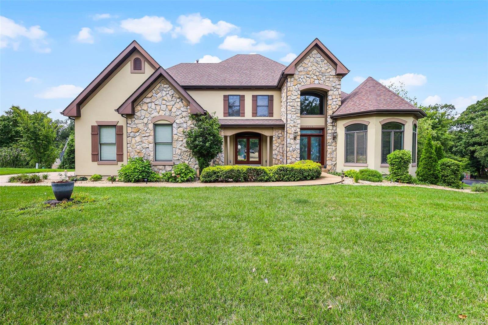 Gorgeous Kirkwood custom 1.5-story dream home opportunity. 2-story stone fireplace with upgraded millwork throughout, open flowing floor plan. The dining room boasts mahogany wood detailing, and the living room features a custom-painted ceiling and angled walls. Spacious kitchen with newer appliances, center island, upgraded cabinetry, breakfast bar, and newer custom-built sunroom. Fantastic natural light throughout. The main floor master suite has coffered ceilings, lg tube, lg closet, and a separate walk-in shower. A two-story entry foyer and a beautiful staircase lead to the upper level with tall ceilings, jack and jill bath, one private bath, and new hardwoods throughout. The finished lower-level walkout matches the top two levels, featuring a second fireplace, wet bar, rec area with projection TV, and 5th bedroom. Walk-in closets, recessed lighting, main floor mudroom, tall solid core panel wood doors, flagstone tile, built-ins, large lot, cul-de-sac, and side entry 3-car garage. Additional Rooms: Mud Room