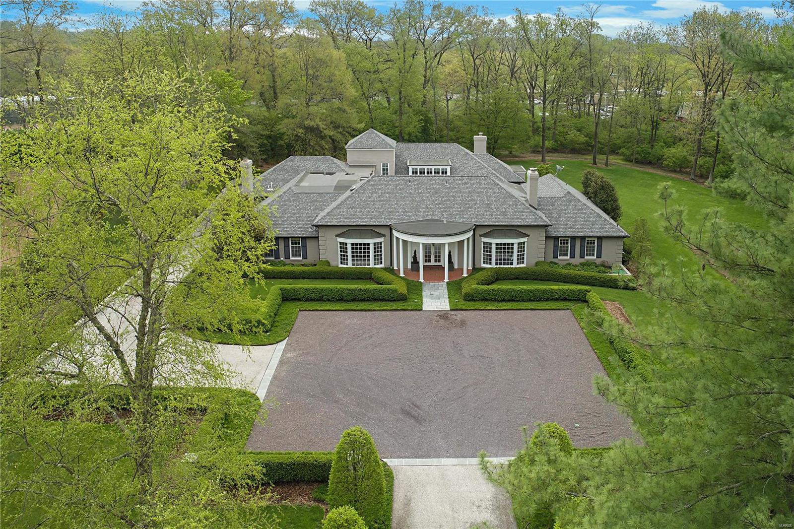 Welcome to this one-of-a-kind architectural masterpiece residing on almost two acres of beautifully landscaped grounds. An elegant, tree lined, gravel drive leads you to an inviting motor court.  Upon entry you will delighted by the stunning design & thoughtful upgrades. The garden courtyard, the heart of the home, brings the outdoors in with every view.  Entertaining is a breeze with the large dining room, sunlit living room, & handsome media room featuring a wine cellar.  The chefs kitchen opens to vaulted breakfast  hearth rooms with built in desks.  Additionally the main floor features a vast primary suite with a spa-like bath & spacious walk-in closets along with an additional en suite bedroom. Separate staircases lead upstairs to three generous bedrooms, two full baths, & a large second family room. An attached three-car garage, mudroom, basement recreation room, & two laundry rooms add to the ease of living. Convenient to schools & shops alike, this home is built for a lifetime. Additional Rooms: Mud Room, Wine Cellar