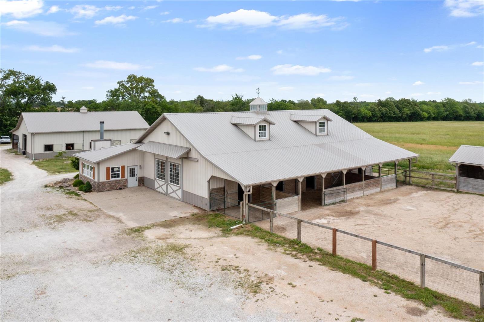 Stunning equestrian facility ideally located within minutes of Hwy 70. The property includes 2 heated barns with 10 stalls, equipments storage, a newer arena with led lighting & fans, kitchen, living quarters, 2 bedrooms, 2 baths, office space, laundry and much more. The 20+ acre property with a 2 acre lake is ideal for the buyer that has personal horses or that wants to continue the current boarding business. This property is a must see!