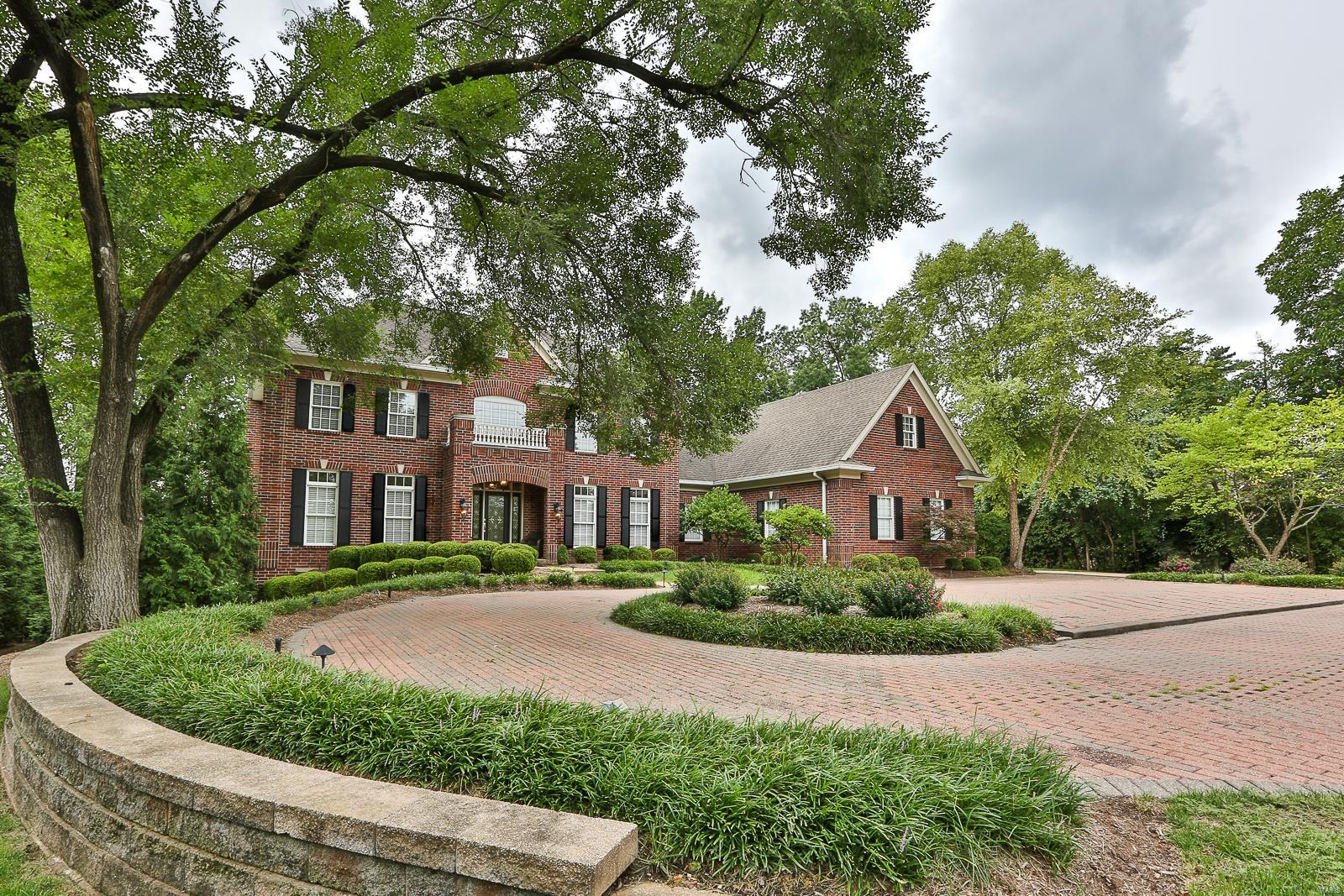 WOW! Custom built ATRIUM 2 story on 1 acre level lot in heart of Town & Country. 6 bedrooms, all with walk-in closets, 5 full/2 half baths. The main floor boasts living-dining rooms, crown molding, great room, gas fplc, atrium stairs to lower level, built-ins, butler pantry/wet bar, vaulted hearth room with gas fplc, spacious kitchen with 42" cherry cabinetry, Corian counters, island, stainless appliances, 6 burner gas range, double oven, breakfast room, planning desk, walk in pantry, main floor laundry, mud room/rear foyer. T-staircase to upper level features the master suite w/ private bath, whirlpool tub, 2 walk-in closets and coffered ceiling. 3 additional bedrooms, 1 with a private bath and 2 share a jack/jill bath. Gorgeous open atrium lower level has 2 more XL bedrooms each w/private baths, plentiful closets, wet bar, family room, gas fplc, media room, home gym, atrium pond. Recessed lighting, screened in porch, 2 sty entry, circle drive, 3 car garage, sprinkler system and more.