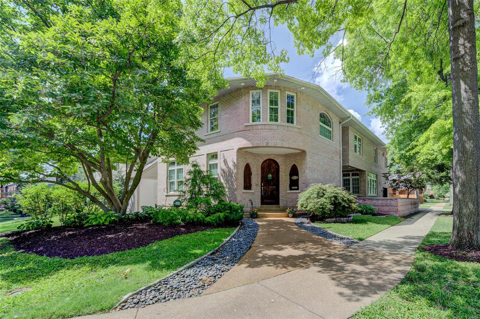 Location, location. Custom built in 2003, this gorgeous brick home in Clayton Gardens offers style and convenience. Fantastic home built in a prestigious neighborhood with high ceilings and bright inviting rooms. The Living Room features a stone gas fireplace, hardwood floors and 15-foot ceilings with floor to ceiling windows. A formal dining room leads to a chef's kitchen and family room. The kitchen boasts custom cabinetry, pantry, gas appliances, double ovens, and center island. First floor laundry and attached 2 car garage with EV plug. Ascend from the first floor on the elegant staircase, to the 2nd floor with 4 spacious bedrooms and a designated office. The wide "hallway nook" is charming. Primary bedroom features a gorgeous ensuite of closets, jet tub and dual vanities. The finished lower level includes an egress window for a future bedroom and plumbing for a bathroom. Enjoy walking in this tree lined neighborhood with Clayton parks, libraries, schools, retail, and restaurants. Some Accessible Features