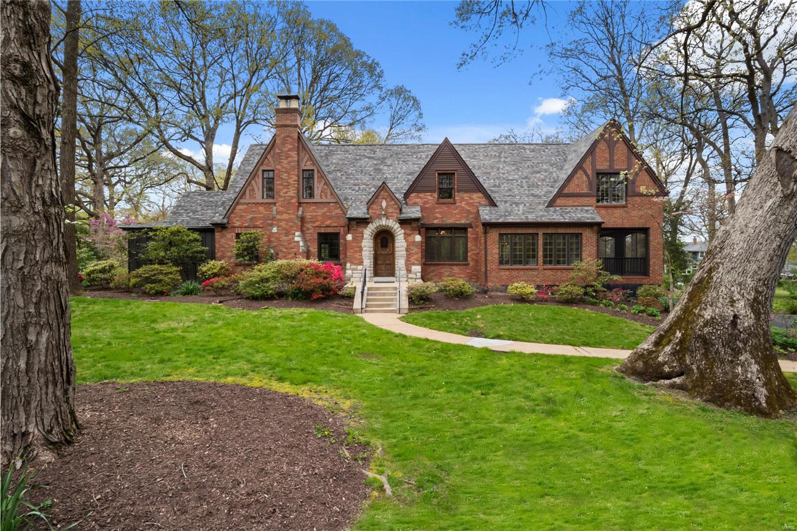 Located in sought after Webster Groves neighborhood, this all brick 1936 historic Tudor home features over 4,500sf, in-ground pool all on nearly an acre. Inside you will see the perfect combination of original character & modern updates. Re-finished wood floors, built-ins, custom base trim, crown molding, & some restored antique lighting located throughout. The chefs' kitchen is stylishly finished w/ custom cabinetry, high-end appliances including a Wolf range, dual fridges & center island that is perfect for entertaining. The upper level is highlighted by the master suite w/ vaulted ceiling, walk-in closet, & luxurious finished bath w/ custom tile work, soaking tub & heated floors. Enjoy the oversized 2nd-floor laundry, en-suite & two additional bedrooms serviced by a hall bath. Other amenities include all renovated bathrooms, partially finished LL, 5 car attached garage, oversized screened porch, deck, stone patio/pool. View the updates list for more details!
