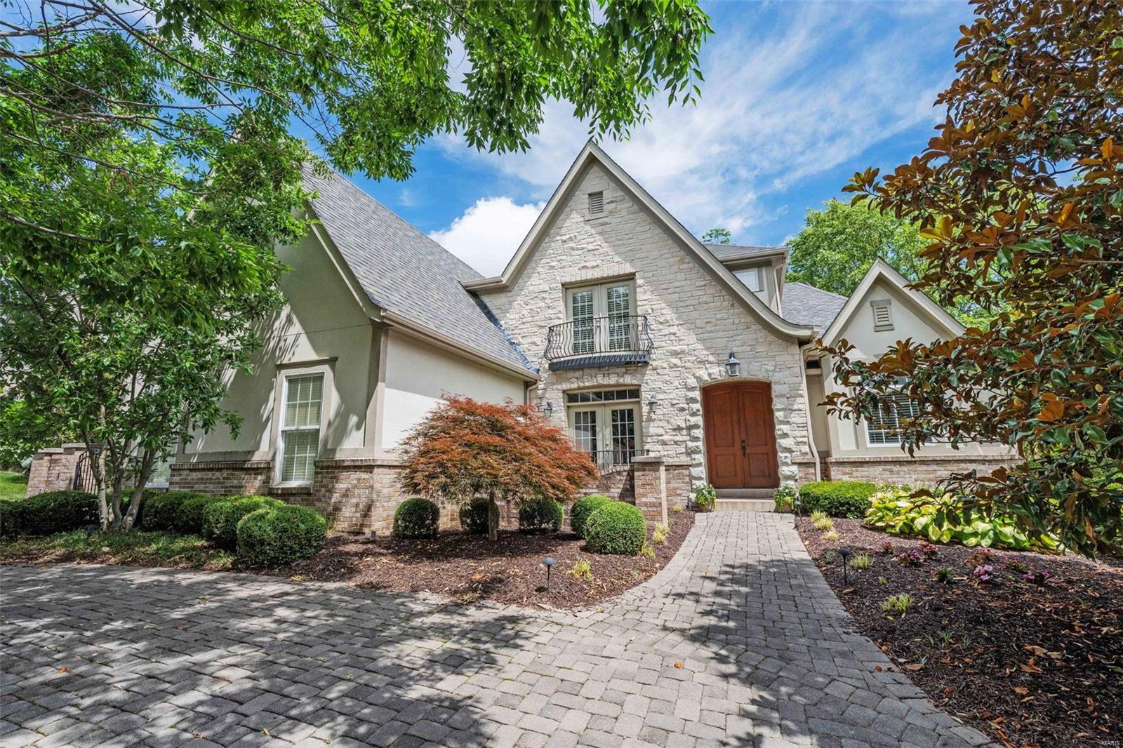 English Country-style home boasts sweeping gables and a brick, stone, and stucco exterior, with a paver circle driveway. Nestled in a secluded lane of custom homes. Features top-of-the-line finishes including Crystal Cabinetry, Wolf and Sub-Zero appliances, Beauharnais limestone tile, and Kohler and Grohe brushed nickel fixtures. The open floor plan is perfect for entertaining, with a 2-story great room with floor-to-ceiling windows and a stone fireplace overlooking the beautiful yard with a covered patio and gas firepit. The main level master suite offers a tray ceiling and a spa-like bath with a soaking tub, heated floors, and a steam shower. Upstairs, find 3 spacious beds plus a 4th bedroom/office with custom built-ins. The lower level offers over 1,600 sqft of living space, including a wine cellar, great room, media room, exercise room, and craft room. The home features fantastic moldings and high-quality doors throughout, with an optional community pool possible with apprvoval. Additional Rooms: Wine Cellar