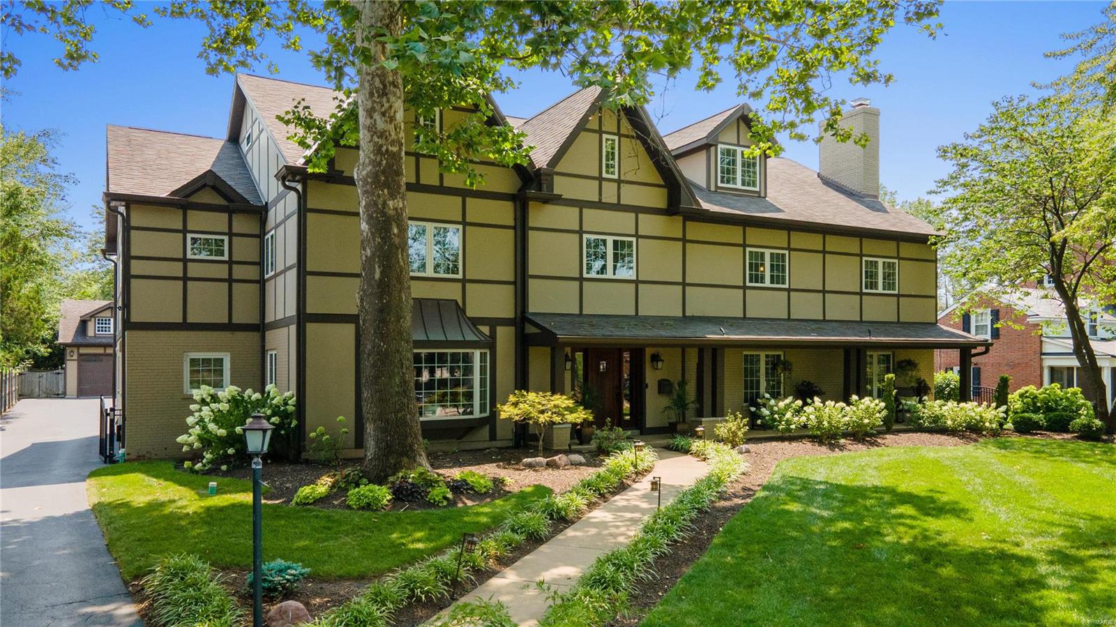 242 W. Jackson Road located in Webster Groves is an amazing before-after story w/the most exceptional 3-story floor plan & an intentionally warm & cozy interior highlighted by dark wood floors & ceiling beams, stone fireplaces & custom built-ins. This 1951 home offers a complete property renovation; 7500sf of living space on a 1/2 acre lot w/a beautiful pool & 3-car detached garage. The grand foyer, w/it's curved staircase & 3-story ceiling height, opens to the formal living & dining rooms set-up for entertaining. A 12ft island anchors the kitchen which has classic cabinetry & countertops, a butler's pantry & breakfast nook; all open to the gracious family room. A stunning home office is tucked in this space too. The primary suite, 3 add'l bedrooms & 2 full baths are centered around another family rm & convenient laundry area on the 2nd fl. An expansive 3rd fl takes game room to a new level including a  room for movie viewing, fitness or guests & bath. Walkable to dining & shopping. Additional Rooms: Mud Room