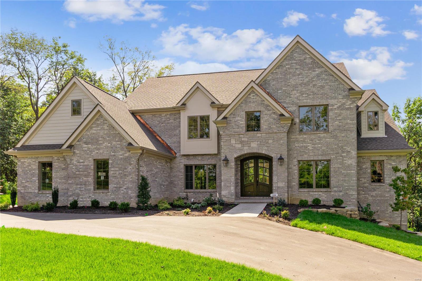 Across from the lush greens of Sunset Hills Country Club & the 43-acre Busch Conservation Area, this custom home by Rehnquist Design & Build is a true masterpiece. Located in the prestigious Mill Hill subdivision, this newly constructed home seamlessly blends unparalleled design & sophisticated comfort. Spanning 6,980 sq ft, this residence boasts 5,400 sq ft across the main & upper levels, & an additional 1,580 sq ft of finished space in the lower level. Thoughtfully curated high-end finishes & custom cabinetry elevate the open floor plan, while expansive windows bathe the interiors in natural light. The 1st floor master suite serves as a private sanctuary, with three full suite bedrooms & a versatile bonus room on the 2nd floor. Outside, a vaulted, covered veranda overlooks the lush backyard, ideal for elevated entertaining. The finished lower level includes a guest suite, entertainment area, wet bar, & full bath, all crafted to the same exacting standards. Duplicate MLS #24057980.