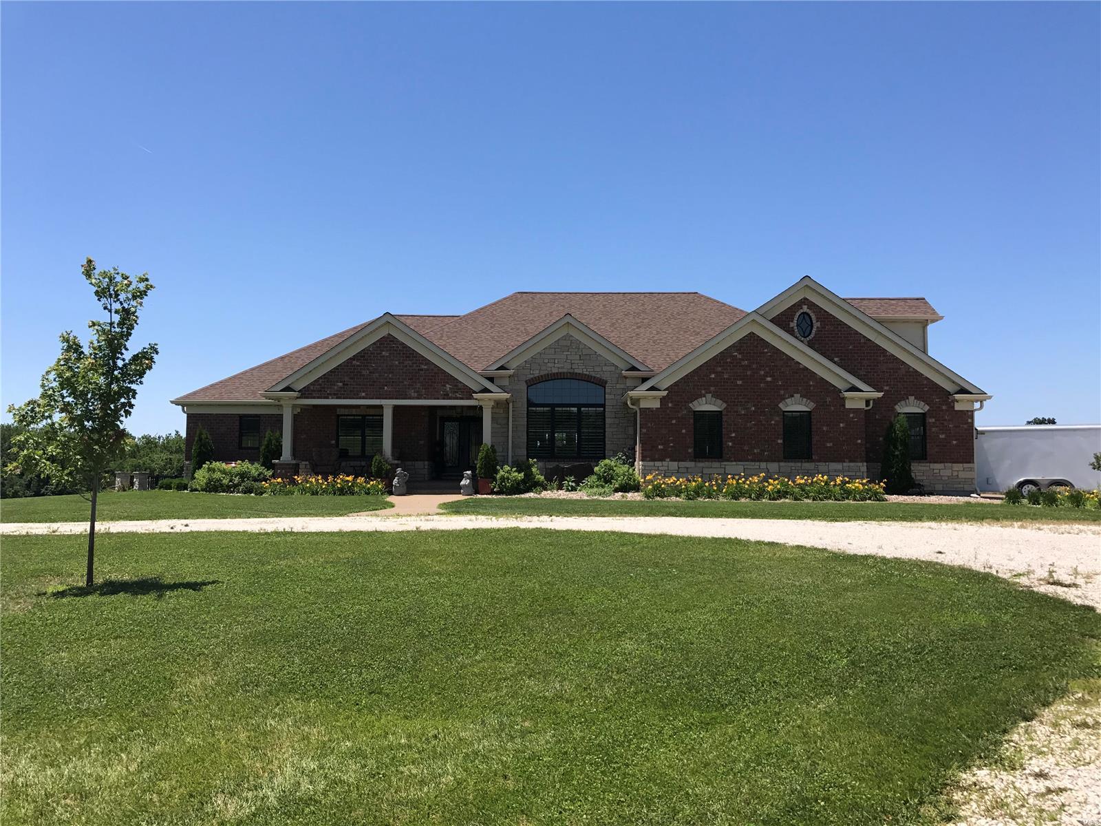 Welcome to this 33 acre m/l estate located in Pike Co. The custom built dream offers 7400 sq.ft. of living space. Full brick & stone exterior, covered composite deck w/open area for entertaining, large concrete patio w/brick pillars. Home features 4 bedroom suites w/walk in closets, total of 5.5 baths, hardwood & tiling flooring thru out, plantation shutters, fireplaces, piano room, formal dining, great room w/fireplace, office, 10'x12' ceilings, mfl laundry w/2 hook ups & sink, billiard room, theater room, family room, gun/safe room, 2nd kitchen & dining for lower level entertaining. Main kitchen features granite countertops, center island w/sink, double ovens, farmhouse sink, walk in pantry, sitting room w/gas fireplace. Home has Geothermal system, public water, spray foam insulation even in interior walls, wired for generator, 3 car finished attached garage w/heat & apartment above. 40x73 matching shop featuring kitchen w/half bath, 6" concrete, insulated w/heat & 3 overhead doors.