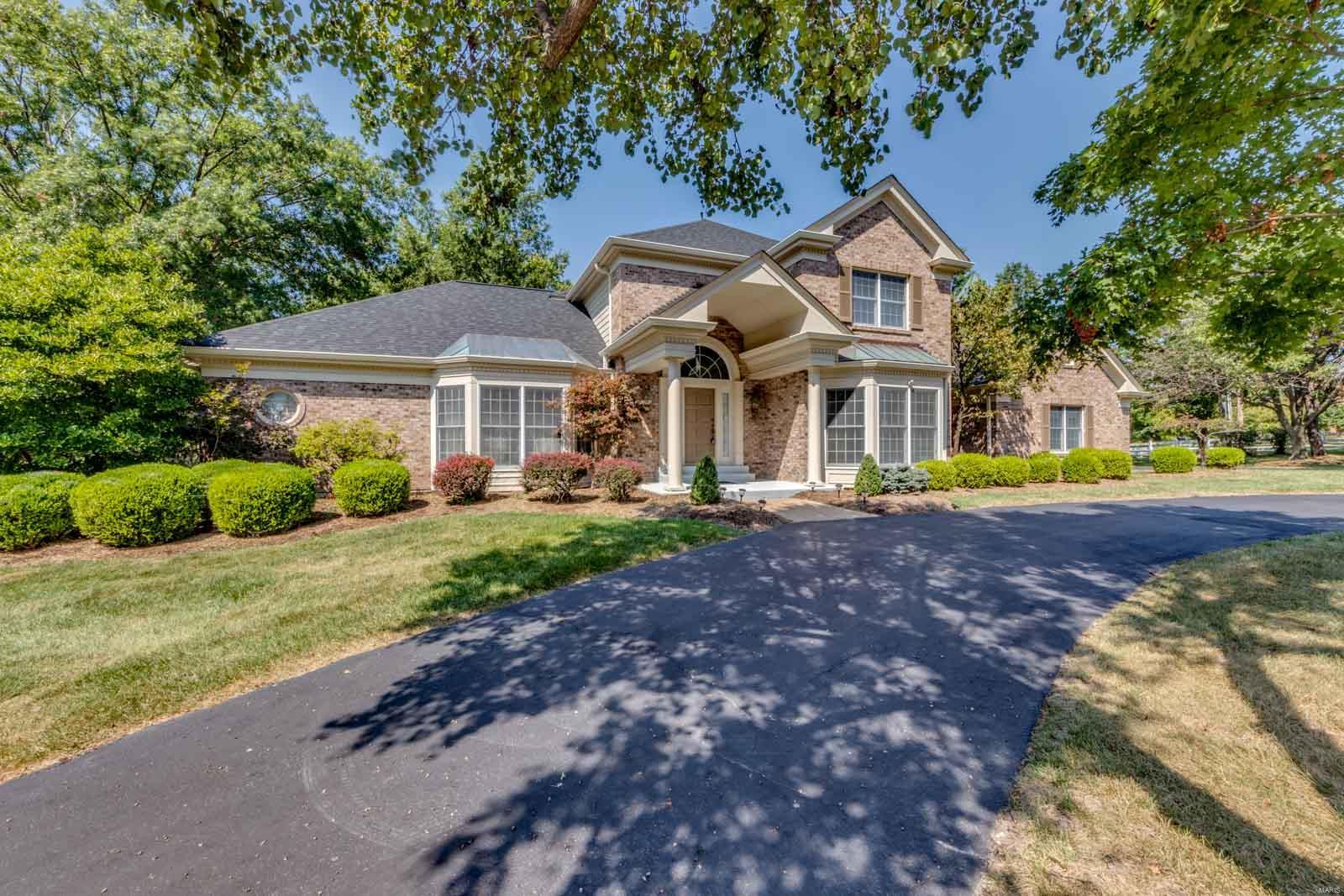 Exceptional opportunity to live in this impressive 1.5 story set within an enclave of 8 homes. 2 story foyer leads to the study with beautiful woodwork & built-in bookcases, a formal dining rm & stunning vaulted great rm with a floor-to-ceiling brick fireplace & Palladian window. The well-appointed kitchen has beautiful 42' cherry cabinets, skylights and oak flooring that span the adjoining breakfast rm and family rm. The coffered primary suite offers a spa like luxury bath with jet tub/shower and French doors opening to a private patio. Upstairs, three additional bedrooms, 1 with en suite bath and 2 with Jack Jill bath. The professionally finished lower level has 2 rec rooms, a 5th bedroom, office, bath and full kitchen. Notable features: extensive stained millwork, newly painted, 2 bay windows, solid wood doors, zoned heating & cooling- high efficiency Furnace (2017,2020), Water heater-2022, Roof-2022, 3 car drywalled garage. Walk to Rossman. Minutes to hospitals & highway 64/270.