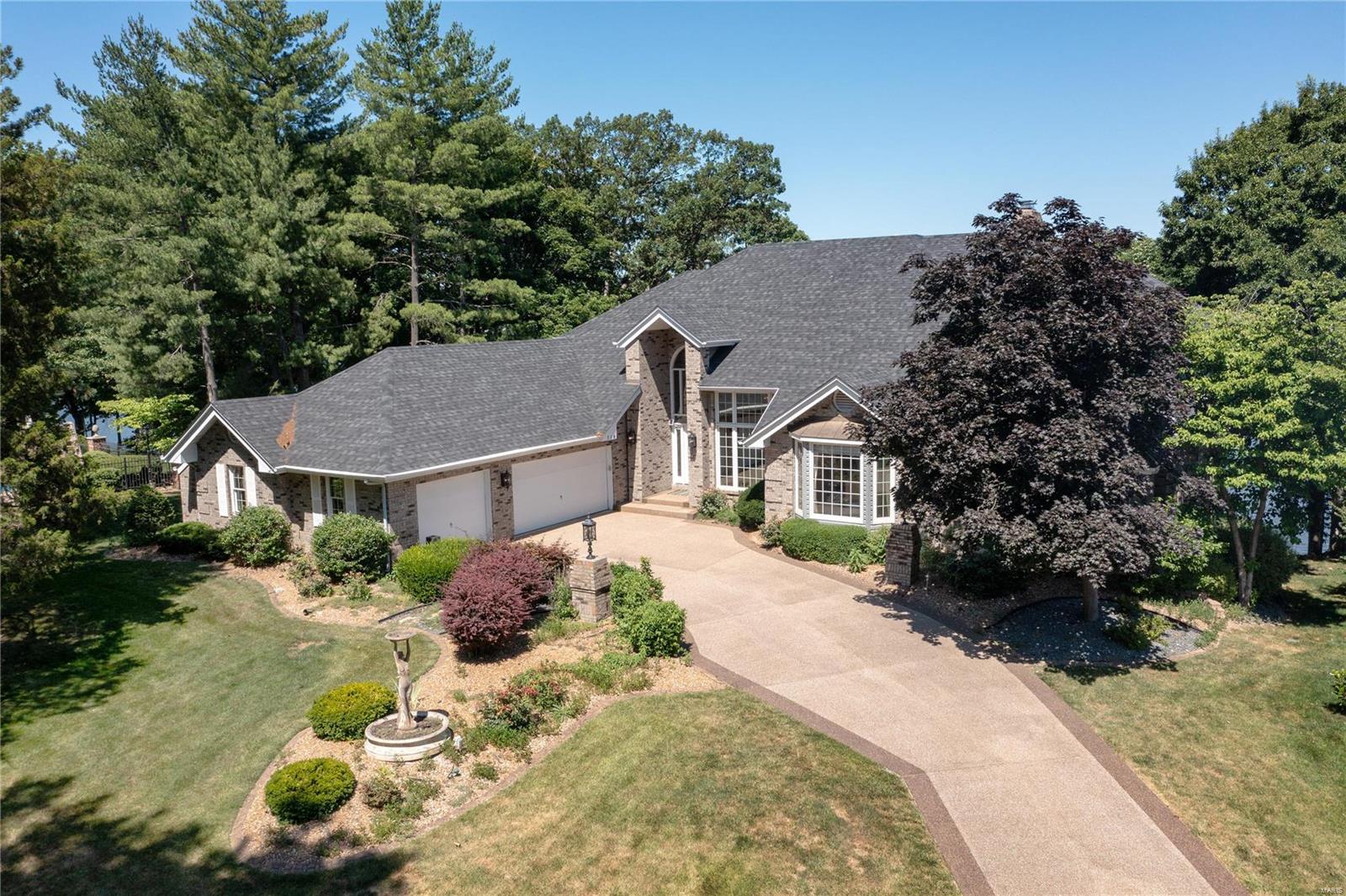 Executive waterfront home with over 7,000 s/f of living space and a spectacular lake view! This stunning home has 5 BD, 7 BA (4+3), an oversized 3 car garage and a .45 AC lot. Features inc a 2 story Entry, 2 story Great Rm with cathedral and beamed clngs, dynamic window wall overlooking the lake, 3 fireplaces (1 is a see-through Grt Rm/Mstr Bdr), main floor Master Suite, updated Lux Bath, custom W/I closets, formal Dining Rm, hardwood flooring, downdraft elec cooktop, solid surface countertops, an abundance of Kitchen cabinets, three upstairs bdrms all with private bathrooms, a Loft/Office, dual HVAC, large composite deck spanning the width of the house, screened gazebo and more. The finished lower level has a party kitchen, Fam Rm, Rec Rm, bdr, huge W/I closet and a spa complete with whirlpool, shower, wet sauna and dry sauna. The ext is all brick and the roof is 1 yr old. There is a seawall and dock. Impossible to describe all this home has to offer. Be on vacation every day!