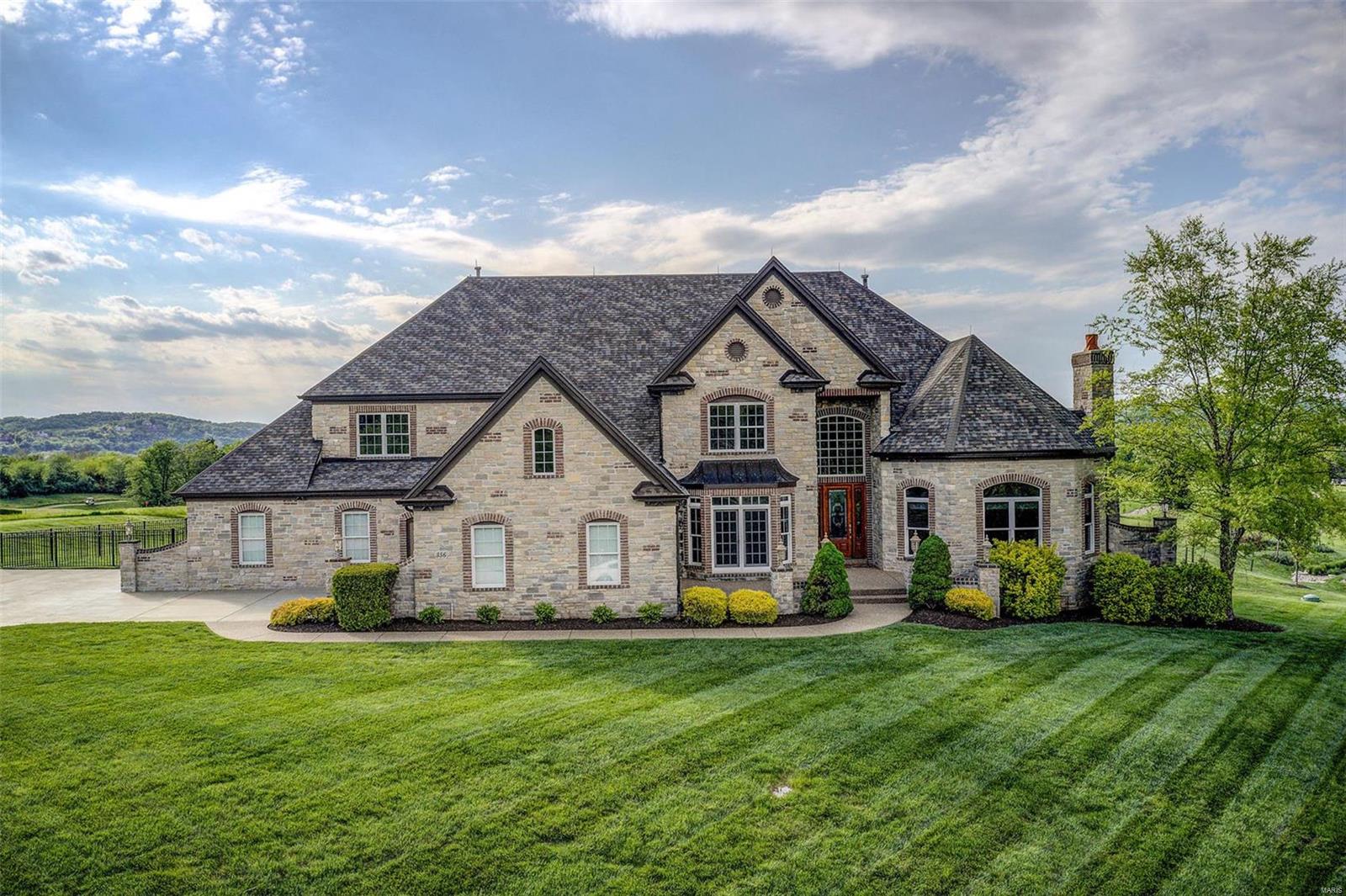 An elegant retreat awaits in beautiful Pevely Farms Golf Community.Boasting 6575 sqft of unparalleled design&craftsmanship. This home offers absolute luxury starting w/2-story ENTRY&curved staircase;elegant DINING RM w/wainscoting,coffered ceiling&arched doorways; stunning STUDY w/exquisite wood panels&stone fireplace; Vaulted 2-story LIVING RM w/fireplace&wall of windows. Pass thru custom bar area leads to epicurean KITCHEN  w/stainless Dacor gas range, SubZero frig, warming drawers&ice maker. Granite counters extend from bar to prep area&includes center island. BRKFST RM leads to patio w/lovely view of 9th green. HEARTH RM w/stone fireplace&French doors takes you to covered side patio.  MSTR BEDRM has coffered ceiling, SITTING RM w/fireplace, 2 large walk-in closets&luxury MSTR BATH. Balcony leads to 2nd floor LOFT& 2nd FLOOR MSTR w/cozy SITTING RM&large walk-in closet. 3 large BDRMS w/private baths&walk-in closets. Finished oversized 4 car garage completes this prestigious property.