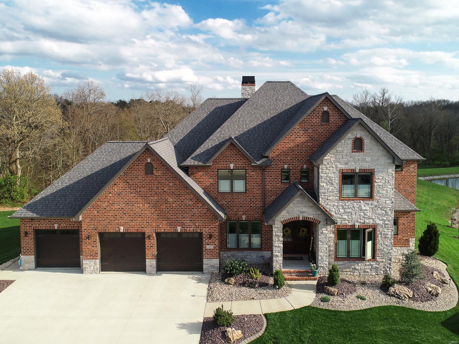 RARE OPPORTUNITY TO PURCHASE THIS GORGEOUS CUSTOM BUILT HOME THAT SITS ON A 1.5 ACRE WOODED LOT W/ LAKE ACCESS. Offering close to 6000 sq ft of living space, this 1 1/2 story home has a great floor plan plus tons of upgrades & high end finishes. Walk into the marble foyer entry & you will immediately love the openness. The great room has cathedral ceilings, a stone fireplace, floor to ceiling windows & opens to the gourmet kitchen which offers custom cabinets, a large island, hidden pantry & top of the line appliances. The main floor master suite has its own door to the covered back deck plus the bathroom features a beautiful tiled shower, heated floors & a large walk-in closet w/ organization. Upstairs you will find two bedrooms that share a jack 'n jill bath & another bedroom that has it's own full bathroom as well. The walk-out lower level features wood beams, an exercise room, a 2nd fireplace, a custom bar & a wine cooler like no other. See additional feature sheet. MUST SEE! Additional Rooms: Wine Cellar