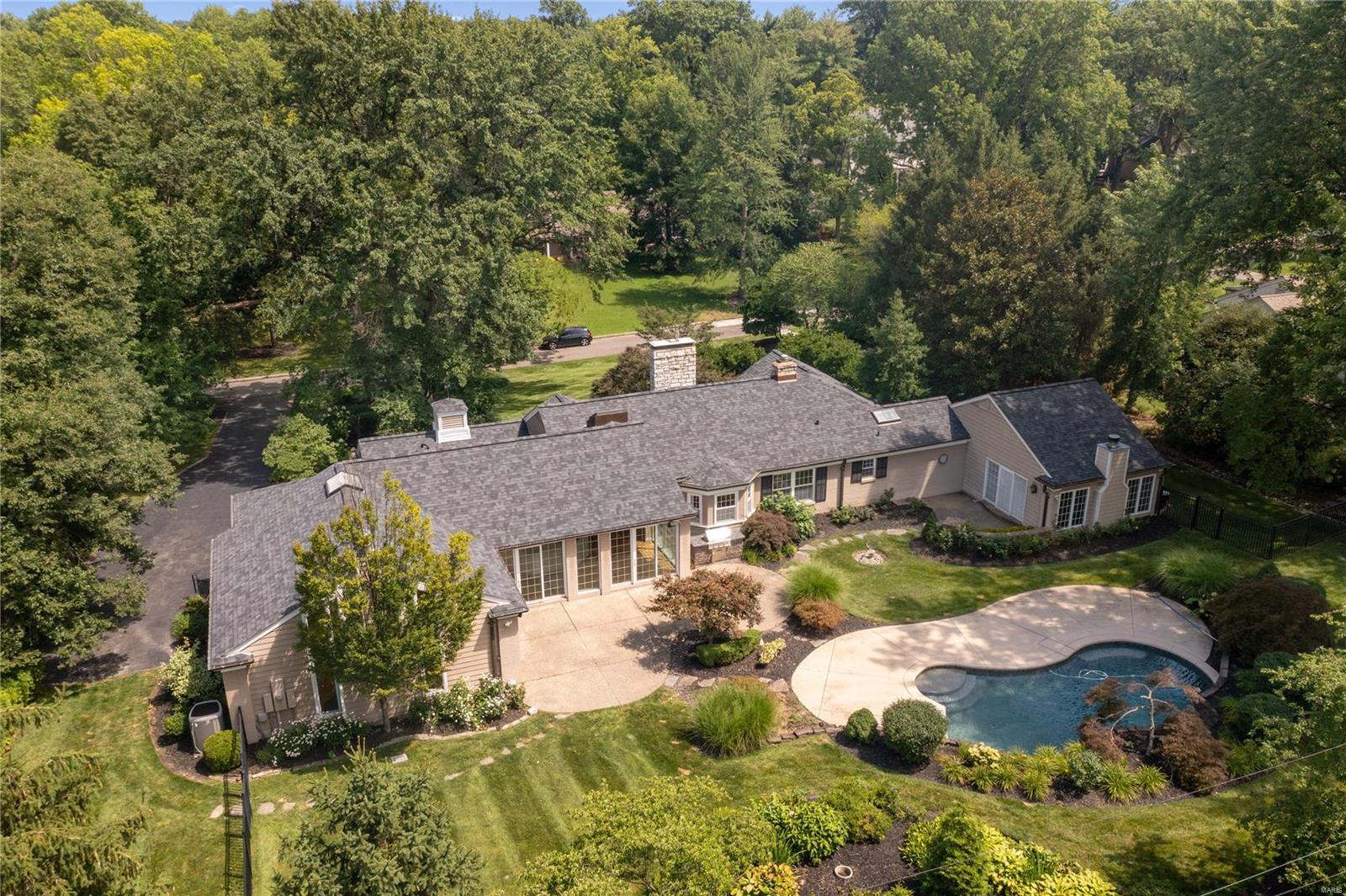 Nestled in the heart of Ladue, this picturesque 1-story home offers a perfect blend of modern luxury. Surrounding lush landscaping & mature trees, create a serene and private setting. Outdoor living is a delight w/ expansive patio and pool, providing ample space for relaxation and entertainment. Bright & open floor plan adorned with sleek hardwoods. Vaulted ceiling Great Room features wet bar & seamless access to the patio. Gourmet Kitchen is complete with top-of-the-line appliances, breakfast room, granite countertops, and a wine cellar down the hall. Dining rm & Living rm add a touch of elegance. Private main floor primary suite boasts a private patio, backyard access, and an updated bath, providing a luxurious retreat. Two additional bedrooms and a full bath complete the main floor, offering comfort and convenience. The lower level offers an additional family/rec room and ample storage space, BONUS two-car side-entry garage. REED ELEMENTARY- LADUE SCHOOLS, this home is a true gem! Additional Rooms: Wine Cellar