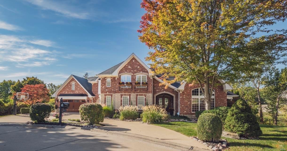 Love life living in the casual elegance of this 1.5 story custom designed brick & stone home. Over 6000 sq ft, 6 bedrooms, 5.5 baths, and 2 laundry rooms. Solid 8’ mahogany double-door front entry opens to expansive foyer and great room with soaring 12’ ceilings and windows. Designer study makes the perfect work-from-home environment, with large windows, 12’ ceilings, fireplace, and private deck. In the center of the home is an expansive 5-ft wide 3-level staircase.  This home offers 4 total fireplaces, wood floors throughout, expansive window walls, and arched doorways are just a hint of the incredible features of this home. The gourmet kitchen is a chef’s delight with a 10’ island, designer appliances of 3 dishwashers, sub-zero pro refrigerator, gas stove with griddle and grill, three ovens, convection microwave, and a warming drawer. An extra large Butler’s Pantry with glassed cabinetry provides a beautiful area for staging for Holiday entertainment.
