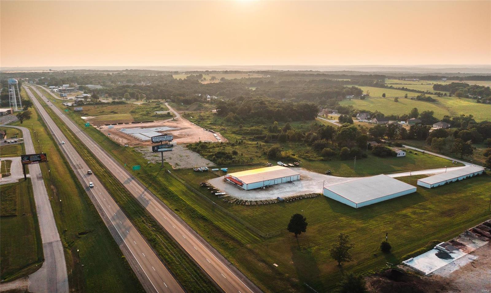 This outstanding 4.6-acre property boasts sought-after I-44 frontage, making it the perfect fit for your business. The main retail building includes a spacious showroom, three offices, a well-equipped kitchen, a conference area, and three restrooms (one with a shower). Additional features include ample storage space and a well-equipped shop with overhead doors. Inside the building, you'll find five propane furnaces with air conditioning for year-round comfort. It's well-lit and secured with a comprehensive security system. This property also includes an 80x160 storage facility with bays and overhead doors, comprising 16 individual storage units, providing both storage options and an additional income stream. After 45 years of service in Central Missouri, the owner is retiring, presenting a unique opportunity for you to establish your business in this prime I-44 location. Don't miss out on this chance to thrive in this bustling area! Location: High Traffic, Hwy/Interstate Frntg