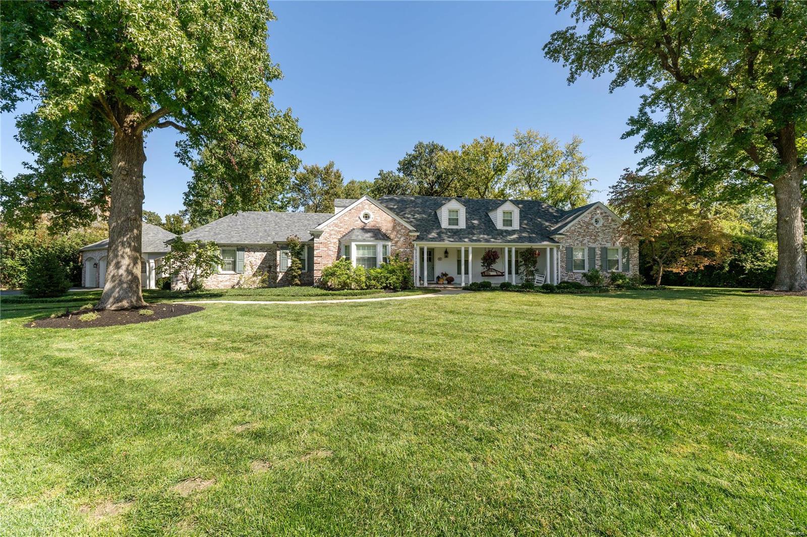 Beautifully updated 1.5 story nestled on a private .82 acre lot in Ladue. Fresh paint, new lighting, new windows, & updated kitchen/baths are just the start! Newly refinished oak floors lead you to a spacious living rm w/ gas fireplace & open to sunny dining rm w/ large bay window. The spacious family rm features beamed ceiling, custom bar, & 2nd fireplace flanked by built-ins. Newly updated kitchen offers custom cabs, quartz counters, stainless appliances & cozy breakfast rm. Primary bedrm suite is a dream w/ walk in closet & newly updated spa like bath featuring comfort height vanity & custom tiled walk in shower. A 2nd bedrm (or great home office) completes the main level. Upper level provides 2 add'l bedrms & 2nd full bath. Walk-up LL boasts new floors & fresh paint in the huge rec rm & 1/2 bath. Sip your morning coffee in the privacy of your back yard w/ stamped concrete patio or on the inviting covered front porch. You will not want to miss out on this Ladue gem!