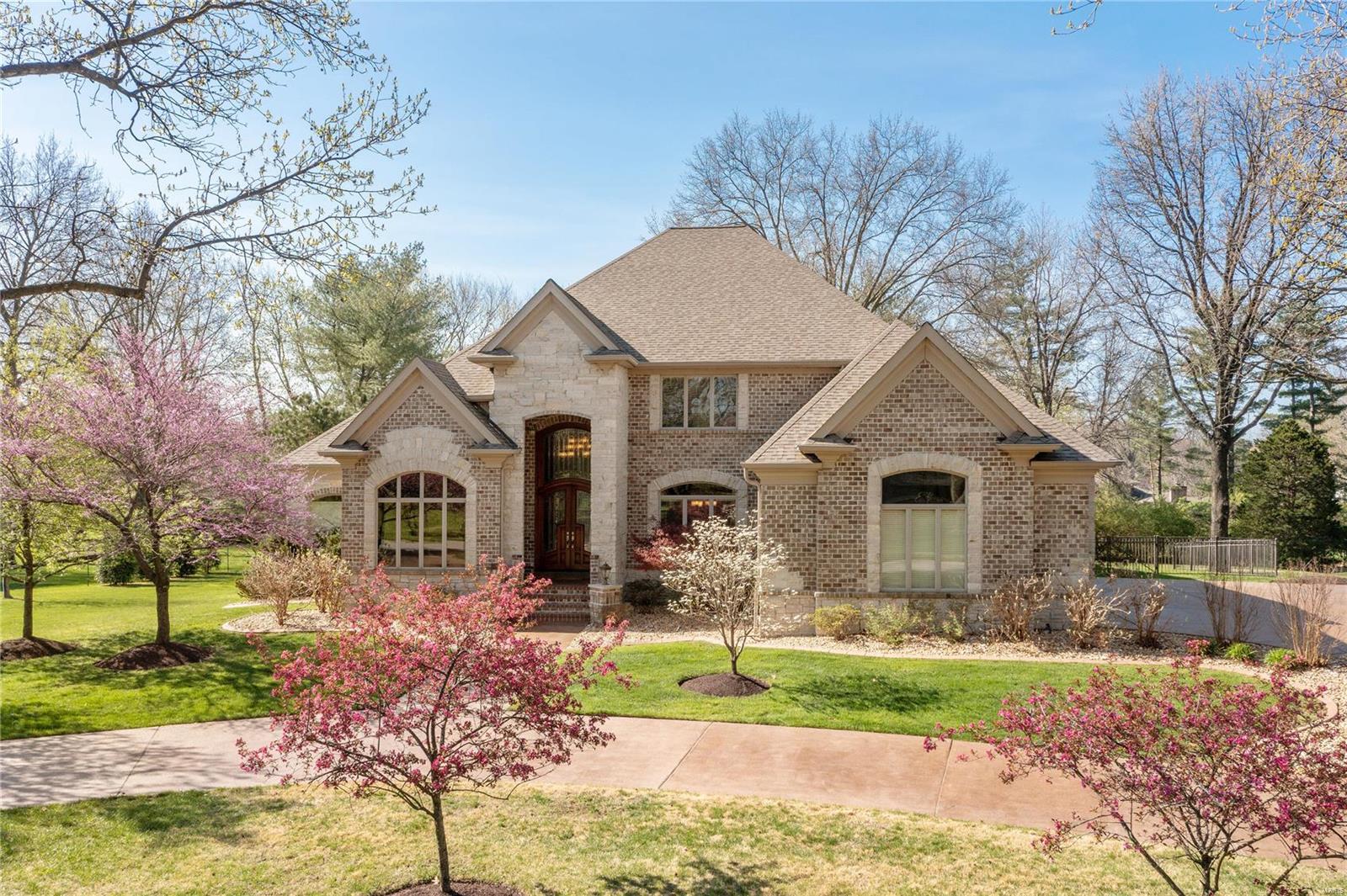 22 North Walling Drive is a gorgeous 16-year-old home, designed for entertaining on a grand scale or living simply every day. This fabulous brick and stone facade incorporates a traditional French Colonial roofline and charming gables while its spacious 4,800+ sq. ft. interior feels warm and welcoming right from the start. A dramatic two-story great room anchors the main level, flanked by a private master suite and kitchen with hearth room.  Enjoy gorgeous views of the property’s green space from every room with windows across the back of the house. The second floor includes 3 additional bedrooms, one with its own private bathroom, and two others sharing a Jack-and Jill. The lower-level was finished with the same high-quality touches as the main living spaces and features a large rec room, easy back yard access, and fabulous bar and home theater room, plus a 5th bedroom and full bathroom. This is a truly exceptional property in a wonderful Creve Coeur location close to everything! Additional Rooms: Mud Room, Wine Cellar
