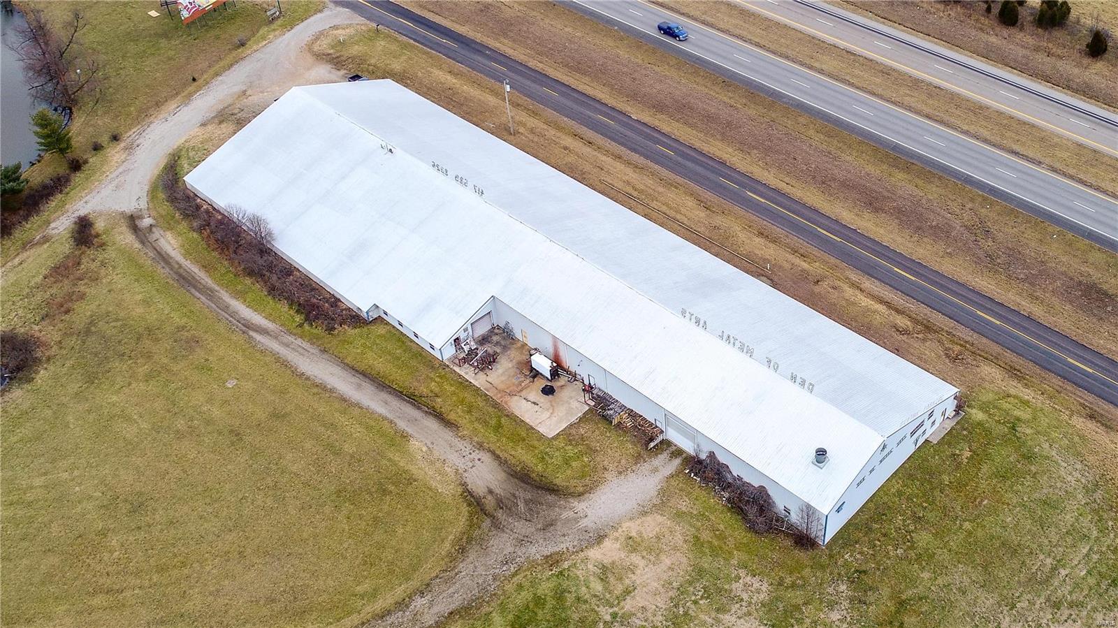 Sale will include 32,720+/- sq. ft. multi-use steel building, 7 parcels selling together totaling 54.5+/- acres, & business with approx. 2,220+/- Sq. Ft. of unobstructed I-44 road frontage.  Taxes paid reflects all 7 parcels.  Building consists of warehouse, showroom, workshop/manufacturing, & storage space including some elevated storage.  There are 3 exterior & 4 interior overhead doors as well as a 14x10x30 paint room with exhaust fan.  There are (4) 200 amp circuit breaker panels, 2 wells (only 1 is used), and an 800 gallon hot water boiler.  Also included in the sale are 3 on-premise 10 x 40 billboards.  Located approx. 30 miles to Springfield,MO & approx. 15 miles to Lebanon, MO.  Call today to schedule your private tour. Complete rubber glaze seal over roof installed 12yrs ago.  Shop & majority of building heat is from a Taylor 1000, Wood Burning Heater while the office space is propane heat only. There is no a/c in the building. Location: High Traffic, Hwy/Interstate Frntg, Other, Rural