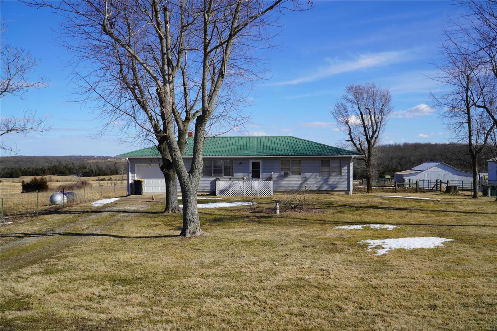 Excellent property for cattle or horses. 389 acres of very good pasture land. Gently rolling and has 13 or more ponds and some of them are spring fed so you don't have to cut the ice. Fenced and cross fenced with a two barns. Hwy frontage for easy cattle hauling. The house was built in 1971 and is in good shape. It has 3 beds and one bath and a lot of room in the basement for storage. One car garage is a nice as well. Excellent neighbors and peaceful place to live. Lebanon school system. This property is ready for your cattle or horses and your family at closing.