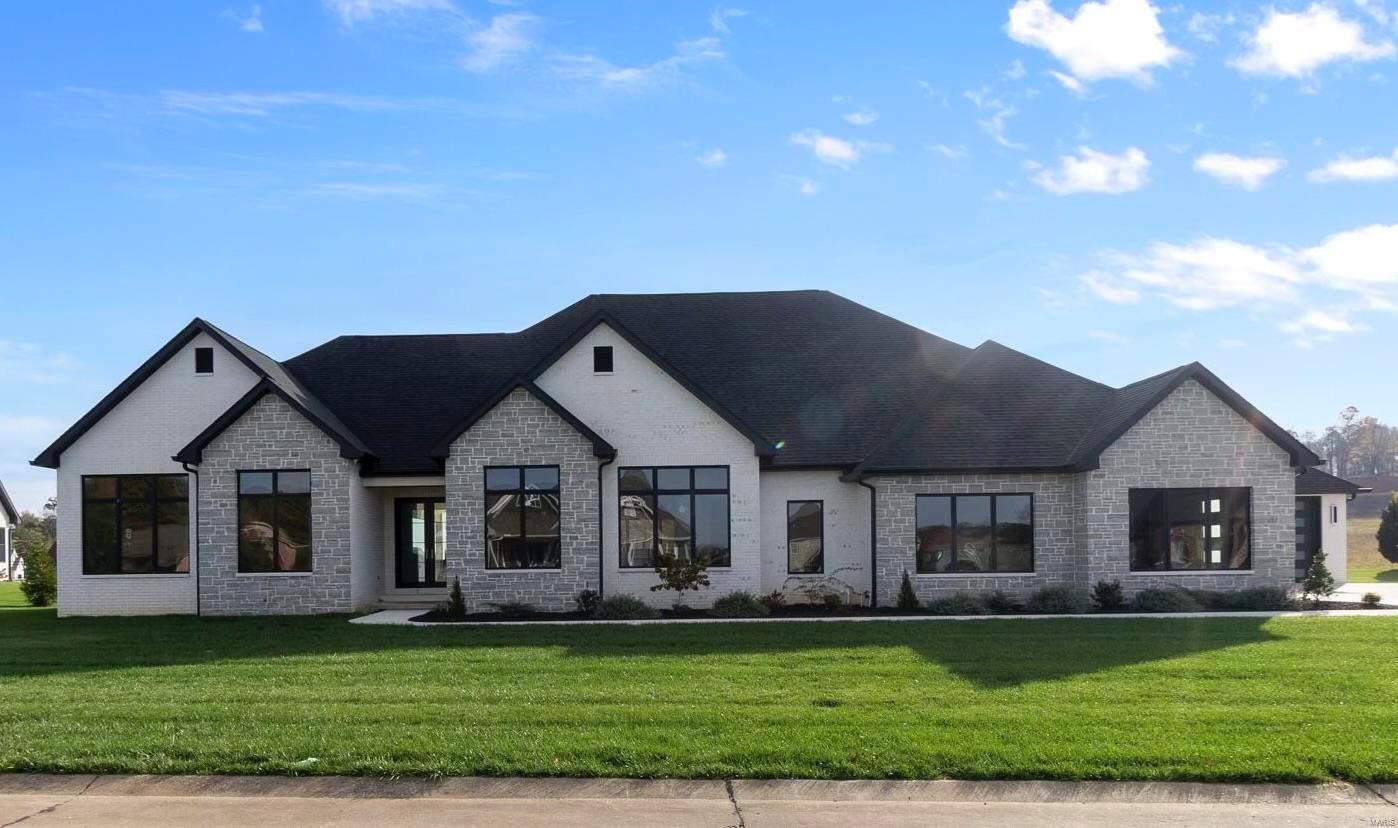 Custom built stunner in Whispering Oaks. Wow factor from the inside out! Custom white oak kitchen cabinetry is gorgeous with a 10 foot white quartz center island. Huge vaulted family room with floor to ceiling stone fireplace that flows all the way outside to the vaulted covered back porch. Walk-in butler pantry & large dining room with lots of light. 4 bedrooms on main floor with 3 ½ baths. Expansive primary suite with doors opening to the pool & gorgeous view of the neighborhood, 8 foot walk in shower & an over the top closet you won't believe. White oak wood flooring throughout. Lower level has SO much space. Family room with custom hickory 16 foot bar. Giant theater room, bedroom with an ensuite bath, additional playroom or great exercise room/office. Relax or entertain outside by your 20x40 inground saltwater pool overlooking your flat yard. The 4 car garage is huge with over 2,000 square feet its more like having your own shop! Fabulous new home in a highly desirable neighborhood