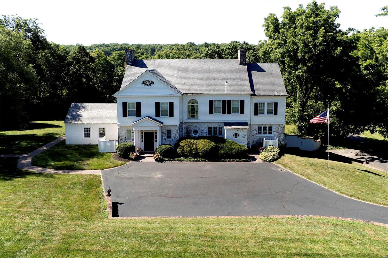 4 acre property in Huntleigh’s horse country adjoining the bridle trails surrounded by horse properties.  Horse area, away from the house but accessible by car or truck, features: two barns; hay shed, eight stalls, board fencing with paddocks and riding area. Classic home designed by Gale Henderson with his signature design features: Southern Exposure, palladium and oval window, breakfast bay, 12’ French door bays. First floor with 9.5’ ceilings, running plaster crown molding and dentil work, chair rail or wainscoting, some raised paneling, some 8’ arched doorways with raised panel casing, 9” baseboards, herring bone flooring, custom book cases, original butler’s pantry with glass front cabinets, wooden countertops, double sink. Adjoining kitchen with some original cabinets, stainless steel counter and double sinks. Second floor with 9’ ceilings, carpet over hardwood, and four sets of French doors opening to Southern balcony. LL rec room and 3 Car Garage. Fabulous southern terrace. Additional Rooms: Mud Room