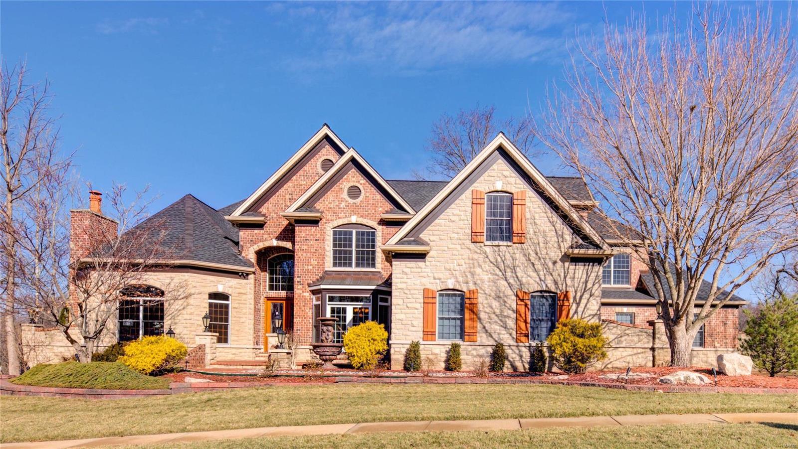 Welcome Home! Stunning 1.5 story in prestigious Eagle Crest Estates. Impressive Architectural Elegance w/ meticulous landscaping. Entering the grand foyer, be impressed by elegant marble floors, grand curved staircase, & architectural detail. Off the foyer find an executive office w/ beautiful woodwork & coffered ceiling & formal dining rm. Great rm boasts high ceilings, 1 of 7 fireplaces, & hdwd floors. Gourmet Kitchen feat custom cabinetry, granite countertops, & SS appliances. From kitchen is bkfst rm that leads to composite deck & hearth rm w/ beautiful stone floor to ceiling fireplace. Spacious living rm w/ vaulted ceilings adjoins hearth rm. Main floor suite flaunts new hdwd floors plus sitting area, 2 walk-in closets, & luxury bath. 2nd level feat new carpet, 3 ensuites, large bonus rm, & 2nd master suite. BSMT offers space for a gym or rec/living area, wet bar & full bath. Add’l feats are MF Laundry, 4 car gar, & fresh paint throughout. Close to shops, restaurants, rec, & hwys.