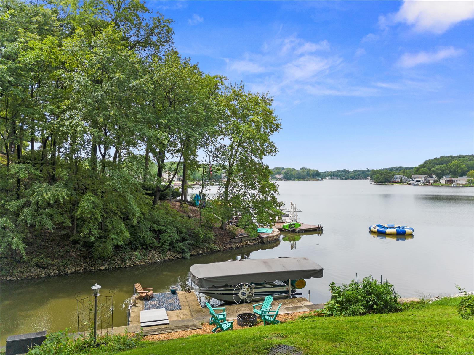 This Fabulous upgraded home has Big Water Views yet Dock and lift are at the mouth of a quiet cove and smooth water.  Contractors' private residence and it shows! The upgrades and renovations are done in high quality, exquisite taste and truly custom. As you approach the front door you will think you’ve walked into the set of Southern Living with lush landscape and gardens. The main level offers large spacious rooms of beautiful plank floors throughout the study, great room, dining room and an amazing kitchen with large windows overlooking the lake. Upstairs is the roomy primary suite, 2nd bedroom w in suite bath and 3rd & 4th bedrooms with Jack n Jill.  Everyone will want to hang out in this incredible walkout lower level!  It offers a true sit-down bar with assorted beverage coolers, game room, family room, billiards, work out rm and only a short walk to the lake. There’s even a beautiful lake bath to shower in luxury when you come in from a day of fun on the water!