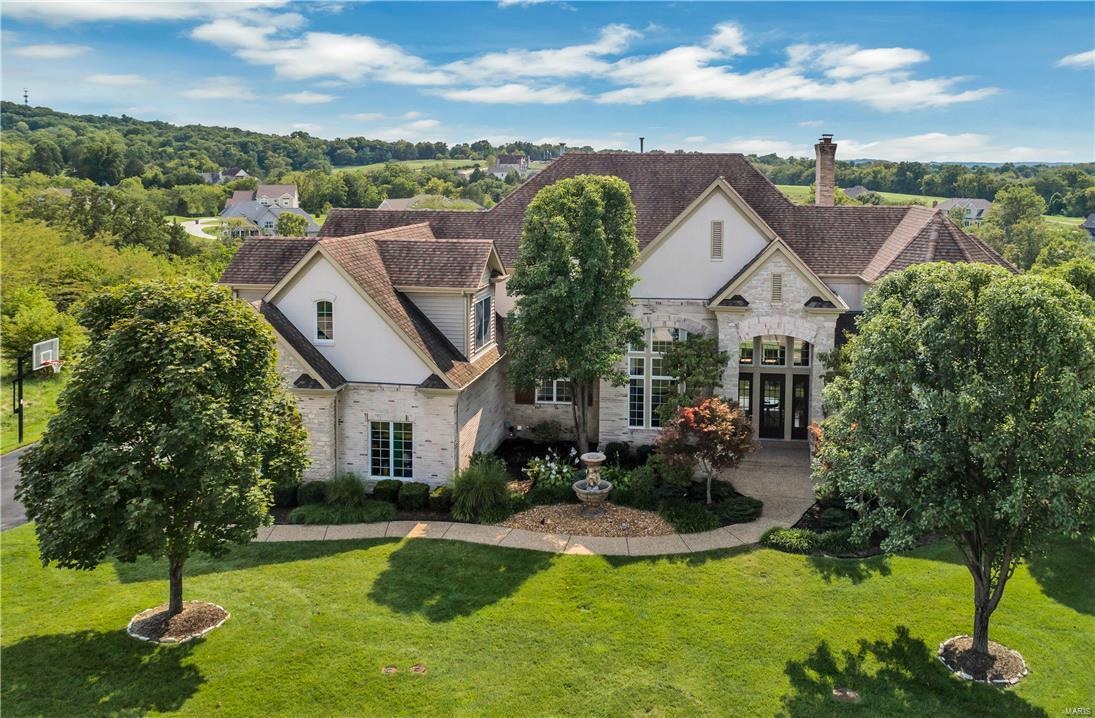 This fabulous 1.5 story with unparalleled design & amenities sits on a park-like 1.2 acre lot with majestic views. There is space galore with over 9000 square feet of living space. The foyer, dining room, great room & library are all 2 stories in height with incredible moldings & built-ins. The library has a ladder up to a private loft with built in shelves. The main floor master features a coffered ceiling, luxury bath & fabulous walk-in closet with closet systems. The kitchen is a cook’s dream with a 5-burner gas cooktop, sub-zero refrigerator & a massive breakfast bar. The upper level features 3 bedrooms, 2 full baths & a bonus room. Enjoy entertaining in the lower level with the huge wet bar, rec room, media room & complete in-law suite. A resort-like backyard includes a large gunite pool, spa & gazebo. Don’t miss this