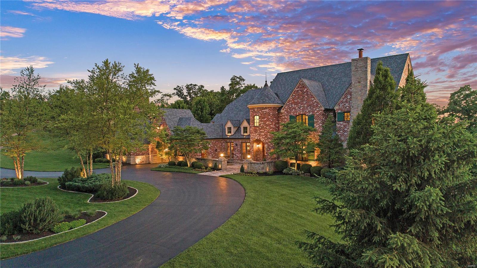 Featured in St. Louis Homes & Lifestyles Magazine, this custom-built, Dick Busch designed English Country Manor home was custom designed & hit all the marks. A perfect family & comfortable entertaining home. The goal was to build on the best lot for river & sunset views. Its a homesite that captures exceptional views from all the windows The goal was exceeded. This home has been host to a family wedding & many large gatherings. Two bedrooms on main floor, a guest LL bedroom & separate guest apartment w/breakfast bar, this home is perfect for company or an elderly parent or small child sleeping on main flr. Terraces, patios, covered balconies, gardens, pool, covered porch w/frpl, built in BBQ and the MO River view created a private oasis. This home offers an open floor plan w/spaces that flow and are functional all the time as well as private cozy spaces like the private den off the master w/frp and balcony with river view. A porte-cochere, auto court, wine cellar. A Spectacular home!