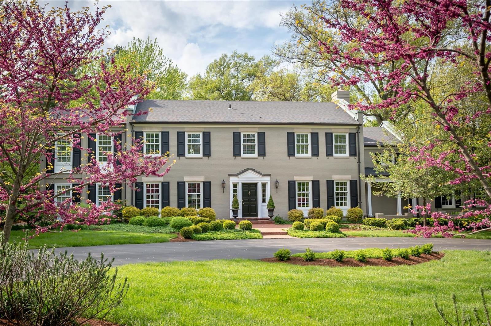 Spectacular Georgian Colonial nestled on 2 private acres and conveniently located in the heart of Ladue offers classic architecture and elegant style. Exquisite details and great flow makes this home perfect for entertaining and everyday family living. Large entry with stunning curved staircase, formal living and dining rooms, cozy family room, kitchen and butler pantry. The second floor features a Master Suite with walk-in closet, luxury bathroom and adjoining sitting room. Three additional bedroom suites and a multi/media family room completes the second level. The LL offers a family room with fireplace, half bath, office, and craft area. Beautiful outdoor living space features a saltwater pool, extensive terraces and lush gardens, a perfect retreat for hot summer days. Extensive renovations throughout. Your home awaits you…