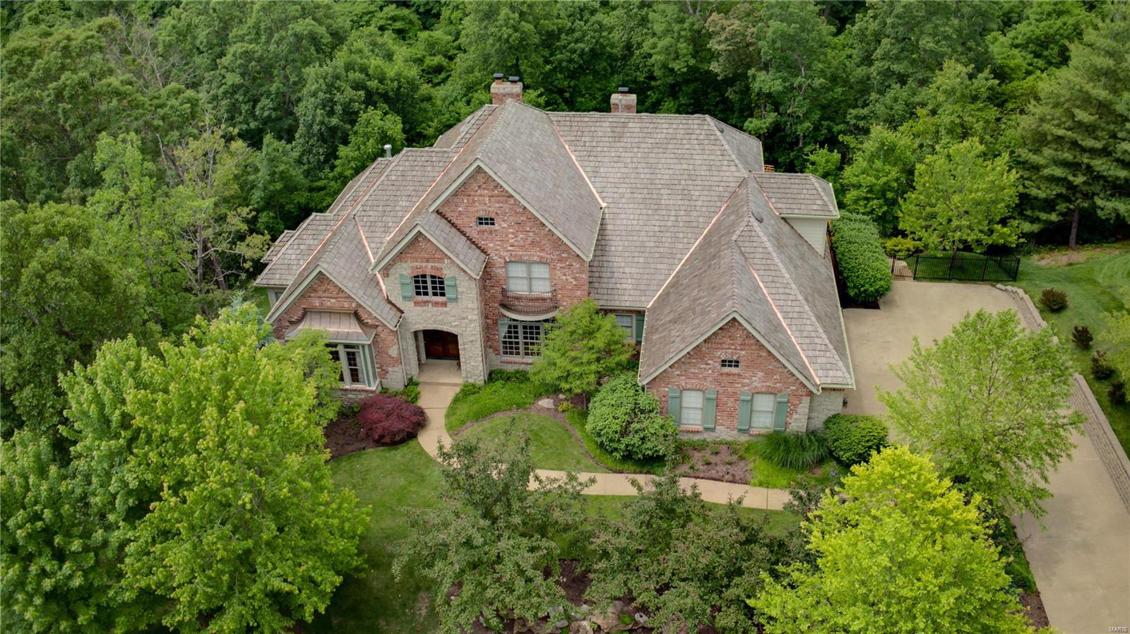 An exquisite property situated in a very private park-like setting with a pool, outdoor kitchen & fireplace that will make you never want to leave home. Additions & improvements from 2010 until today include a new kitchen island and custom hood, Venetian plaster, Pool w/newer pool pumps, some newer light fixtures, Patio, Pergola and yard, newer roof & newer Theater Equipment, New $60K+ deck in 2020, updated power room, new window treatments, new microwave, All bedrooms have private baths and 2nd floor and master have newer carpet. The kitchen is a chef's kitchen.The lower level is perfect for entertaining featuring a bar (there is another bar on the main floor), exercise room, theater room, & pool changing room attached to the full bath. The Study is a study in excellence with richly paneled walls, built in cabinets & vaulted ceiling. Four full masonry fireplaces, ceiling speakers, custom window treatments, custom ceiling treatments thru-out as well as extensive moldings.