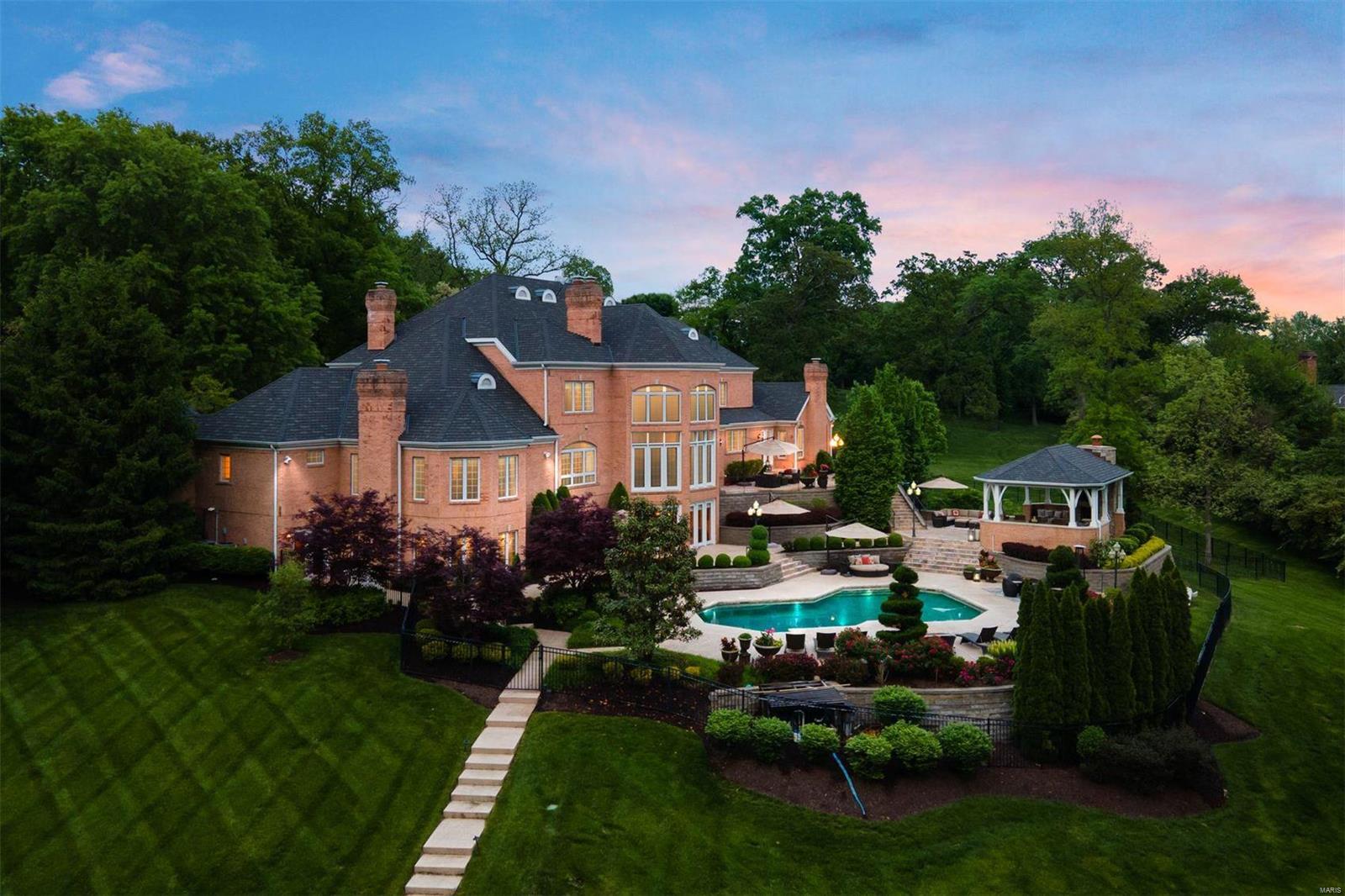 Now this Huntleigh Woods home has it all! Situated on one of the larger lots with exquisite outdoor entertaining spaces like no other estate in contention. Outdoor covered veranda with family room & outdoor kitchen overlooking the pool, tennis court and rolling 4.2 acres. Gorgeous entry foyer with 4 custom Fortuny chandeliers with expansive views of the property thru the living room floor-to-ceiling windows. Dual study/dens, dining room, master wing with dual dressing rooms, kitchen and hearth room on main. 4 suites on  upper with a 2nd laundry room. A walkout lower level that leaves one wondering why they would ever want to leave - over 4,500 sqft of finished space for the best in entertaining - family room overlooking pool and tennis court, kitchen, full bar, massive game room, billiards & card room, wine cellar, fitness room, possible bedroom and one-of-a-kind attached pool house quarters. Over-sized 4 car garage with access to 1,088 sqft of storage in the unfinished lower level. Additional Rooms: Wine Cellar